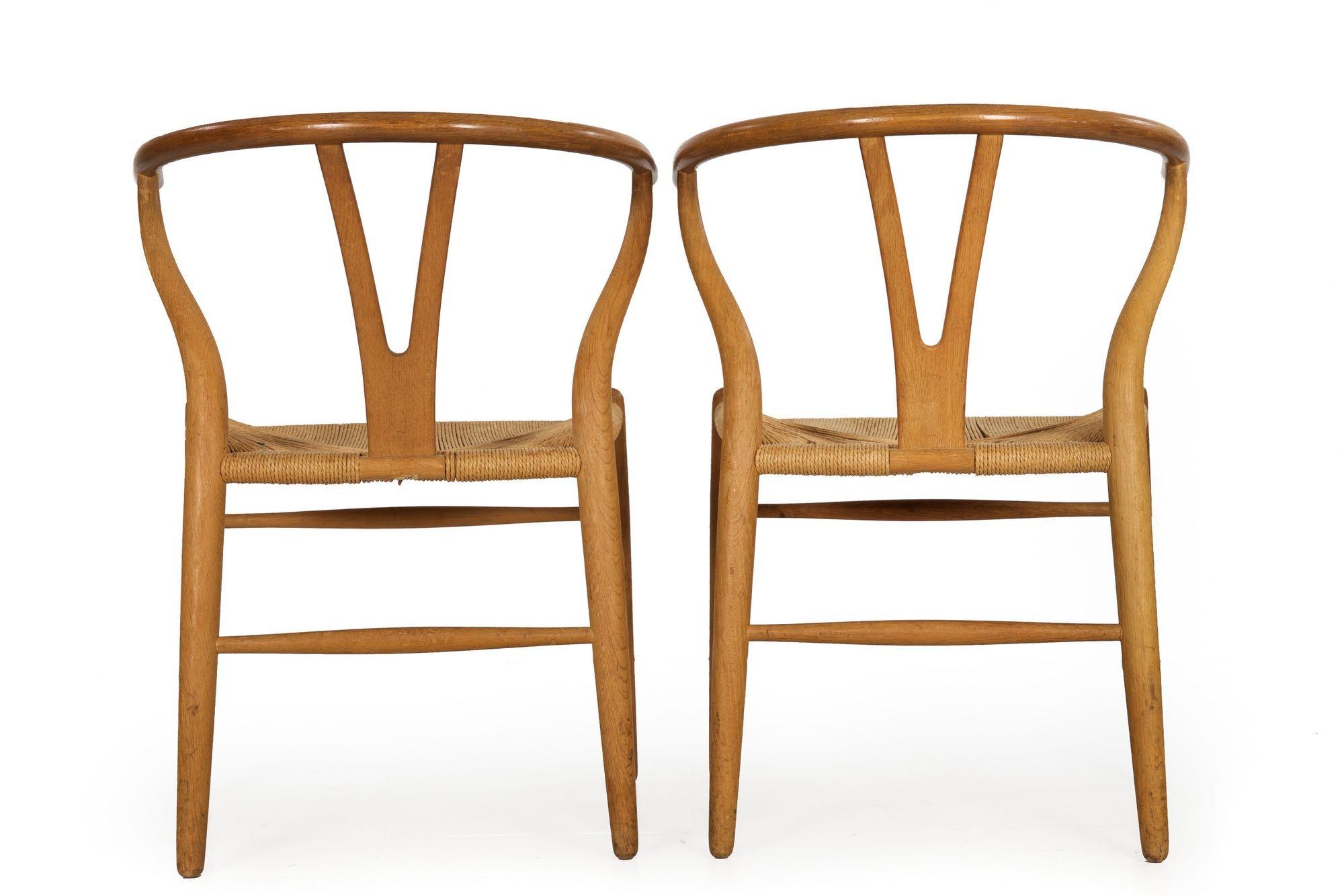 Danish Pair of Patinated Oak “Wishbone” Arm Chairs by Hans Wegner circa 1960s For Sale