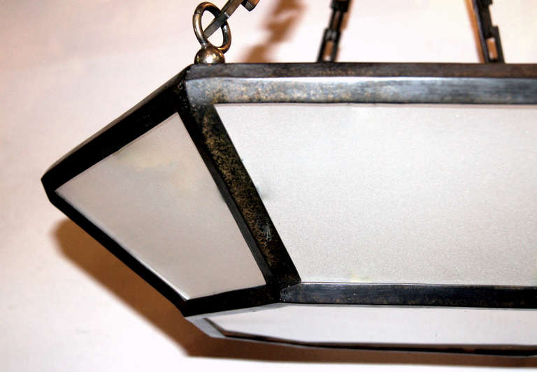 Pair of Italian 1940's bronze light fixtures with 6 interior candelabra lights, original patina and frosted glass insets. Sold individually.

Measurements:
Drop: 26