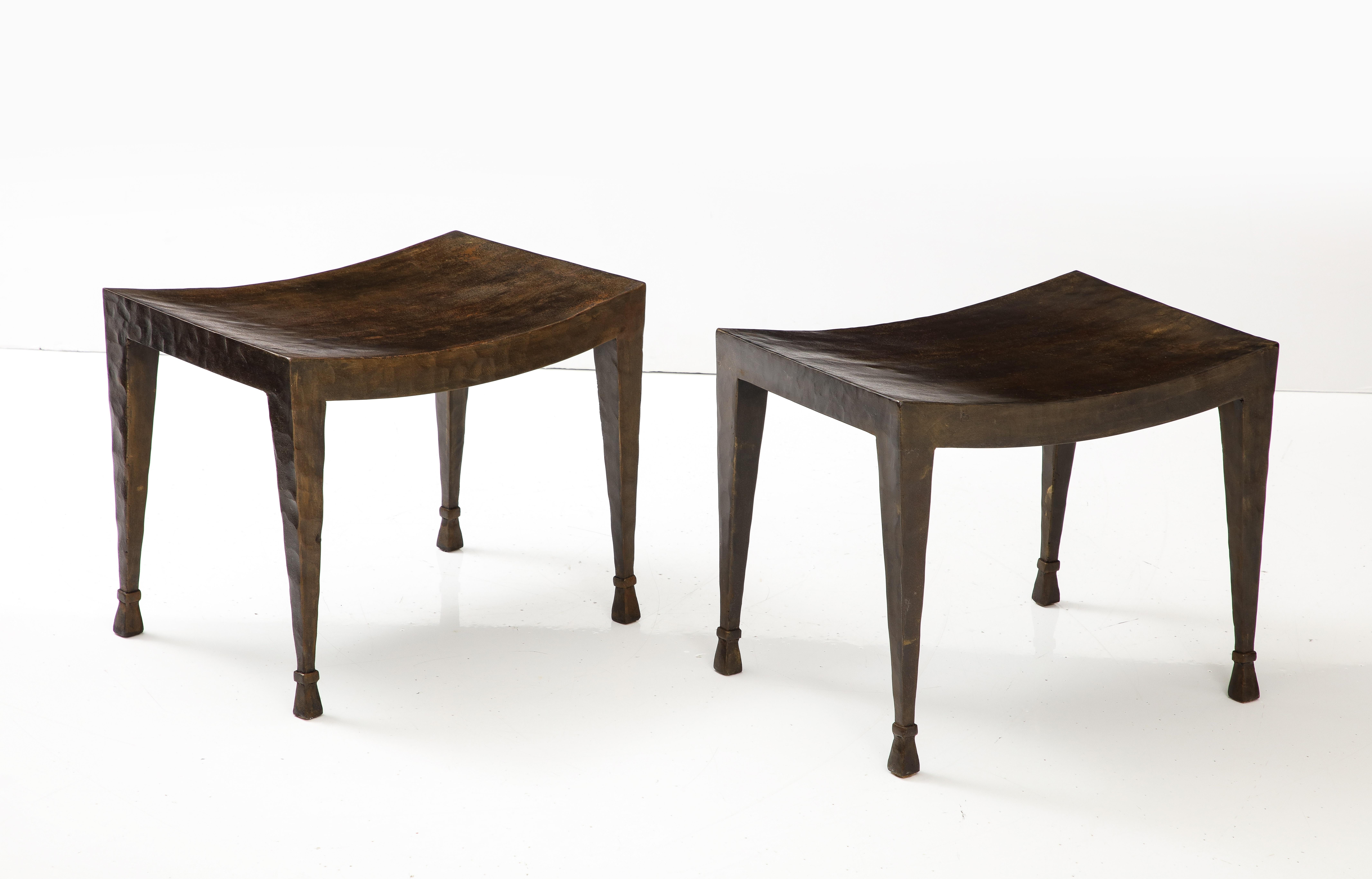 A fine pair of patinated steel benches with a 
