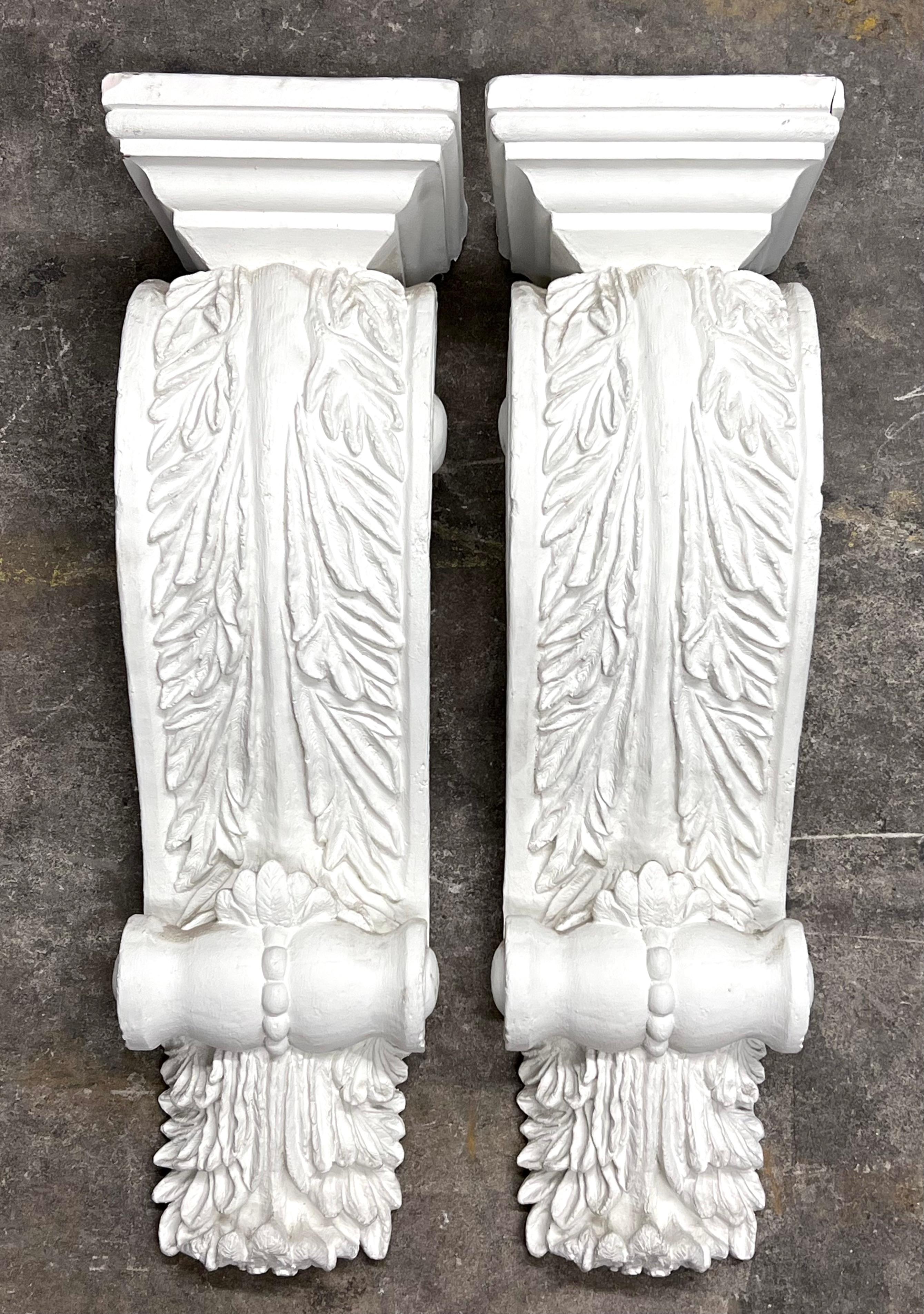 A pair of Renaissance Revival Plaster Corbels. Both look to have been pulled from an architectural setting. Each corbel has an installed metal bracket on the rear for hanging installation. The tops also have holes in which may have housed lights?