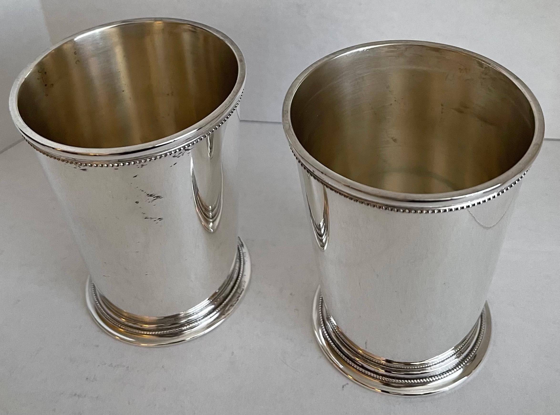 Pair of Patrick Henry silver plated julep cups. Beaded rim and fluted base. Newly polished to a high shine. Stamped on the underside Made in England.
