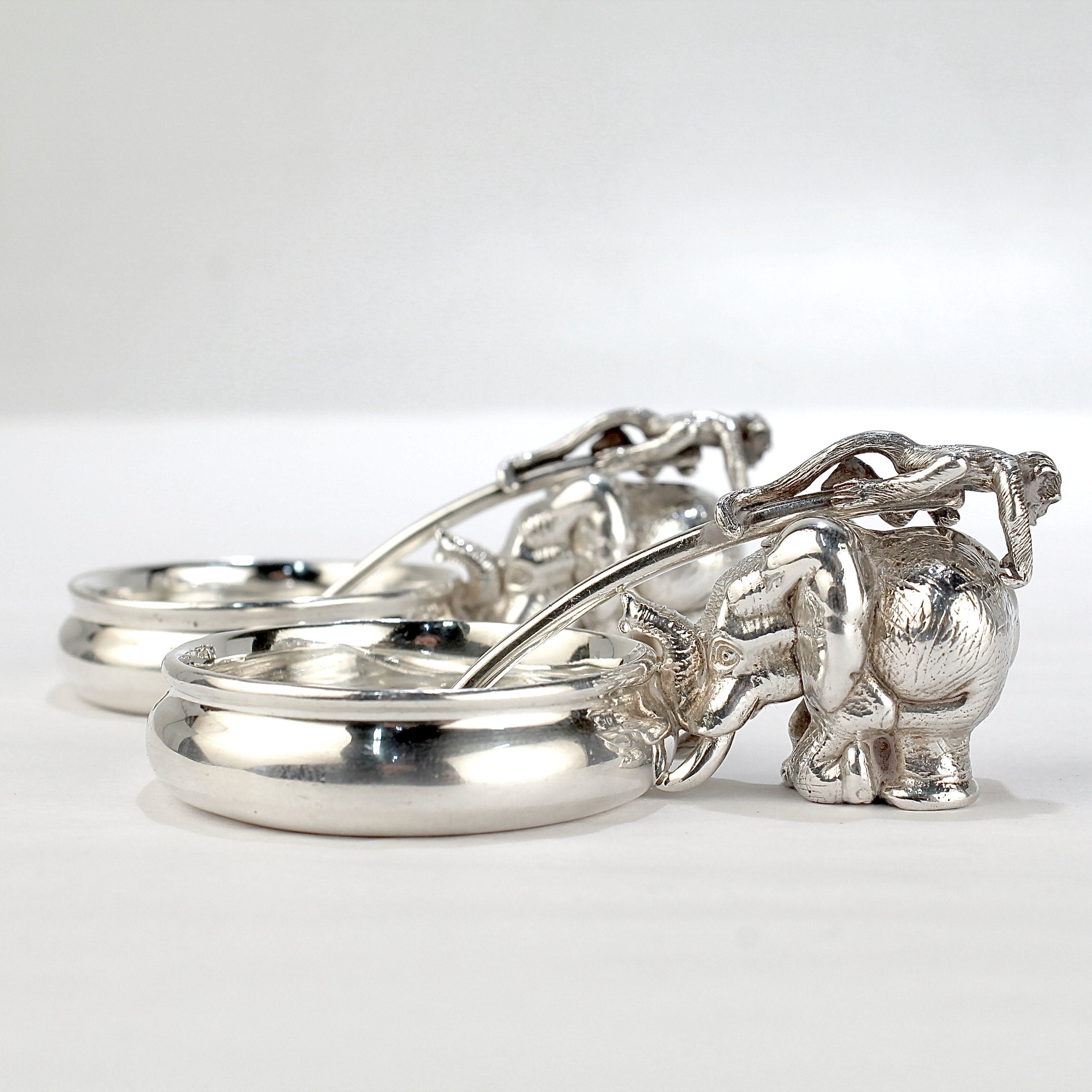 A fine pair of sterling silver figural mustard pots or salt cellars.

By Patrick Mavros, the Zimbabwean luxury jewelry maker. 

First made in 1998, the Ele mustard pot is modeled with an elephant to one side and is accompanied by a monkey handled