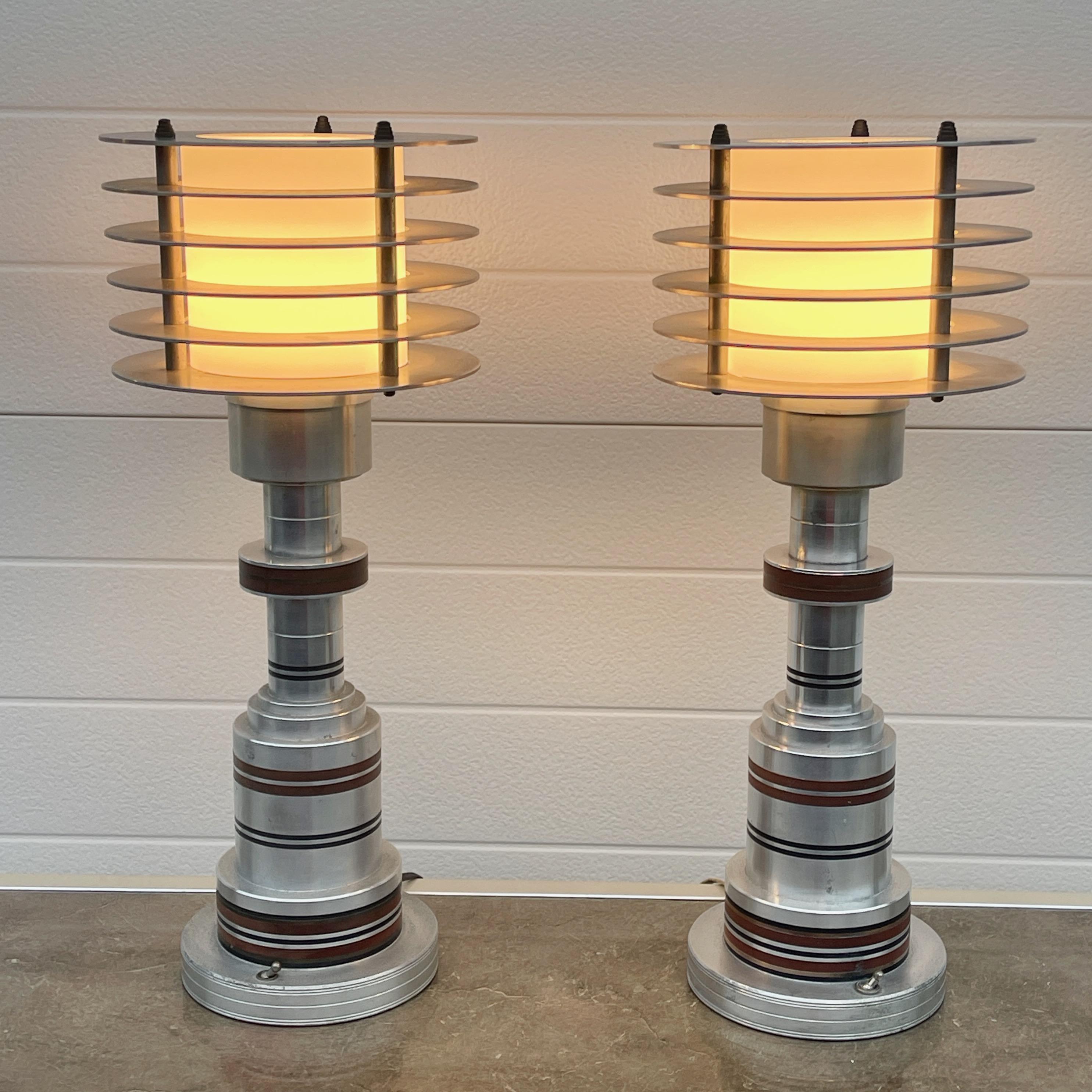 Pair of original Pattyn Products model 310 lamps with original Pattyn stickers on the bottom of both lamps..
Streamline Moderne aesthetic, evoking a sense of speed and movement, featuring a six-disc stacked shade surrounding the lightbulb.
The