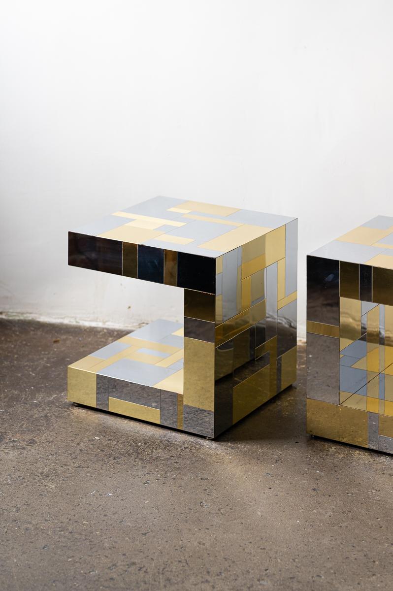 Pair of Paul Evans Cityscape chrome and brass end tables, c. 1970s

These classic side tables from Evans' Cityscape line feature a boxy cantilevered design, clad in a patchwork of mirror finish chrome and brass colored metal panels. 

Each table