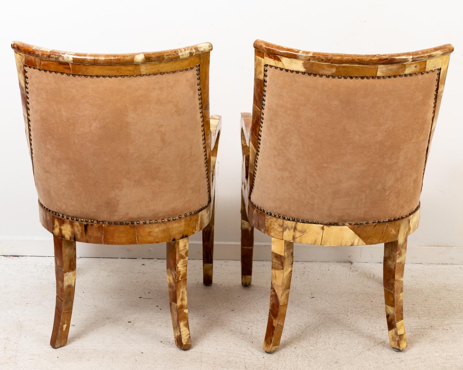 Pair of Paul Evans horn chairs with scrolled armrests, upholstered seats, and metal nail head trim. Please note of wear consistent with age.