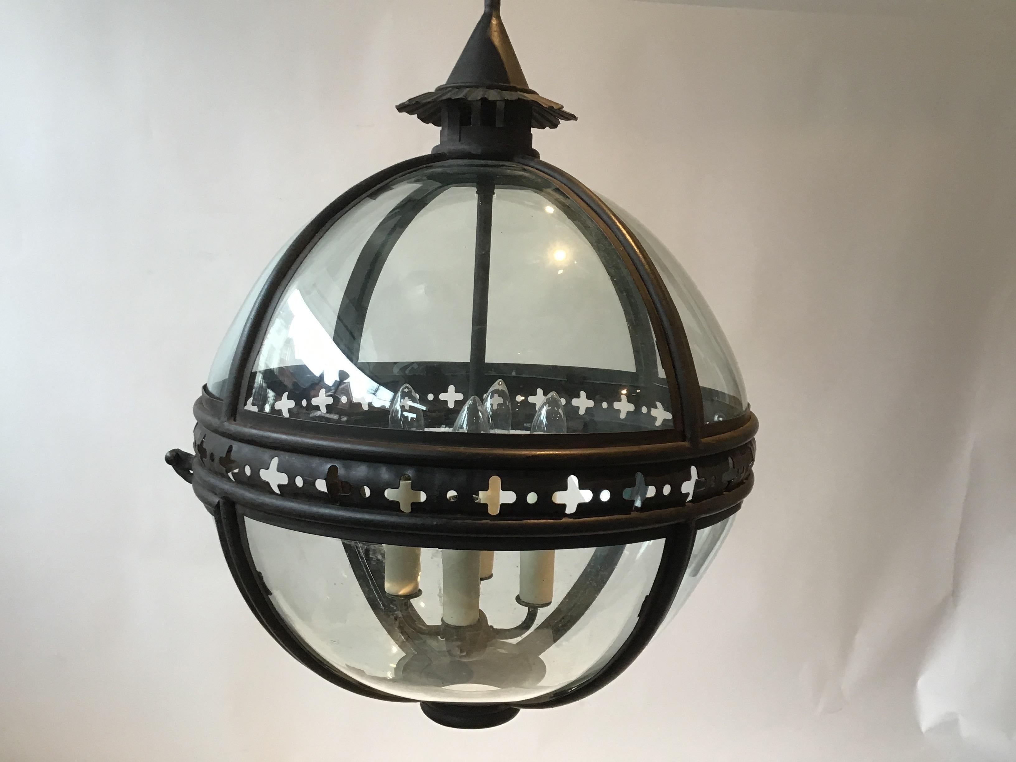 Pair of Paul Ferrante iron and glass orb chandeliers.