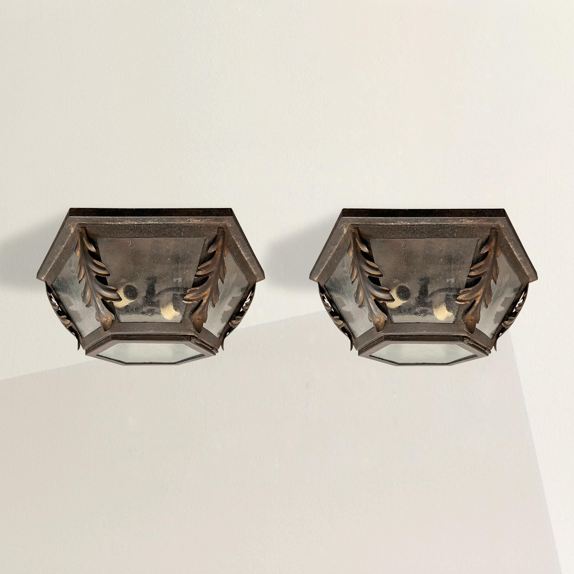 Experience the exquisite craftsmanship of renowned American iron studio, Paul Ferrante, with this extraordinary pair of hand-wrought iron hexagonal flush mount light fixtures. The hexagonal shape adds a touch of contemporary flair while the applied