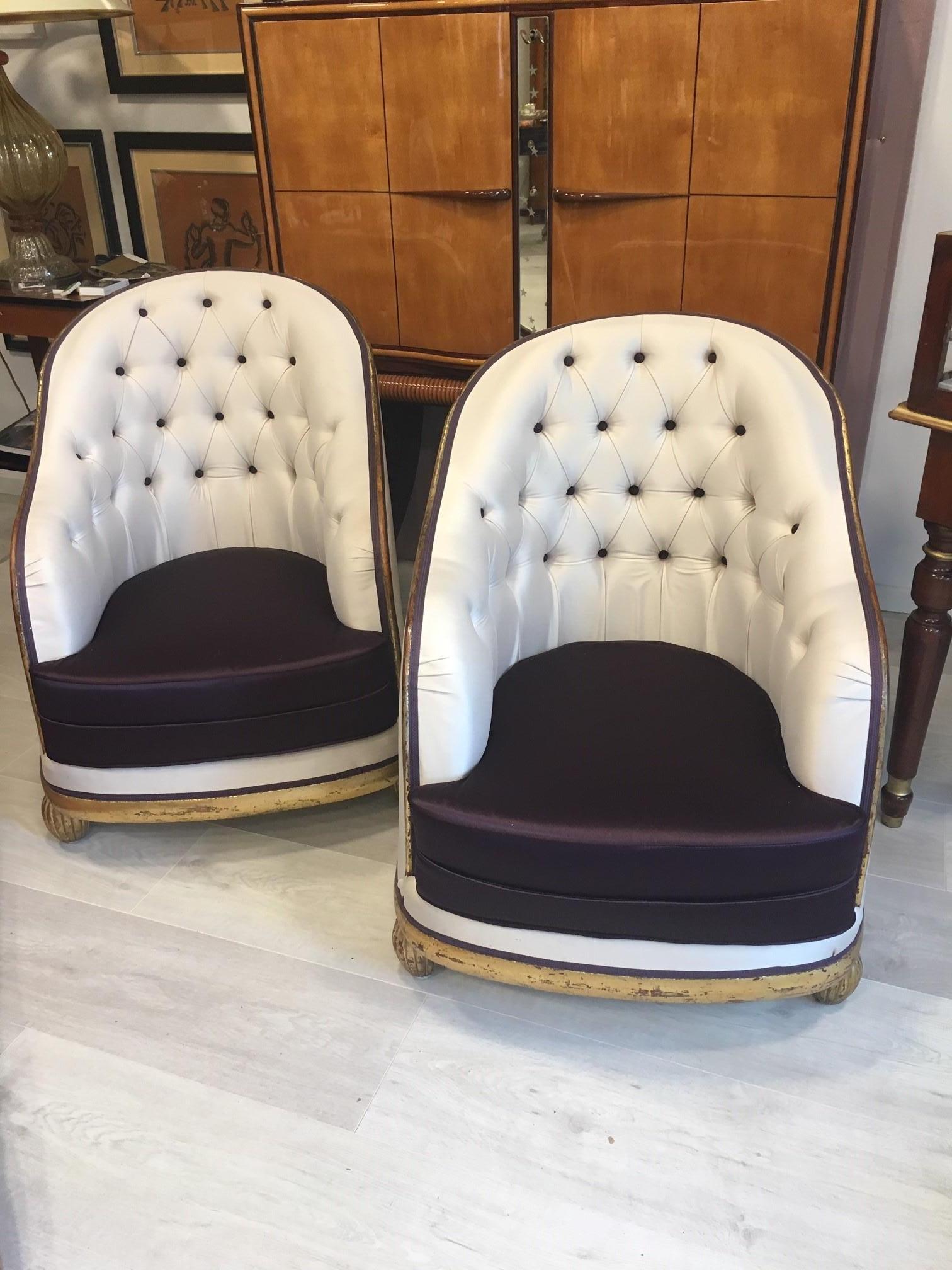 Extraordinary Paul Follot Art Deco armchairs from the 1920s are made of carved and gilded wood. 
The chairs have a wide, curved backrest that extends over solid armrests and rests on legs. 
The lines impress with the high back and the ribbed,