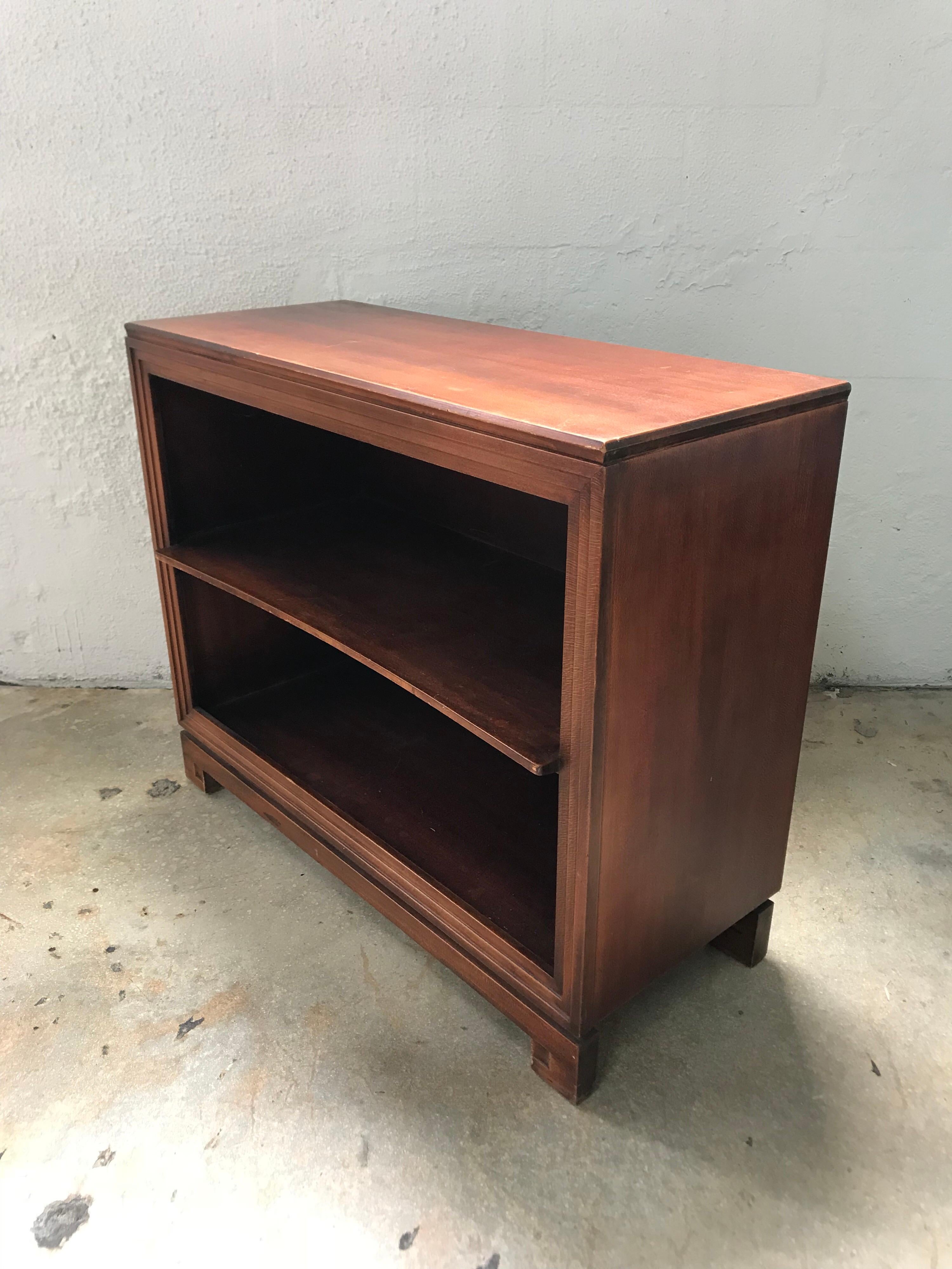 Fully encased mahogany bookcases with a stepped trim detail and bowed internal shelf designed by Paul Frankl for Johnson Furniture Co. price is for the pair.

 