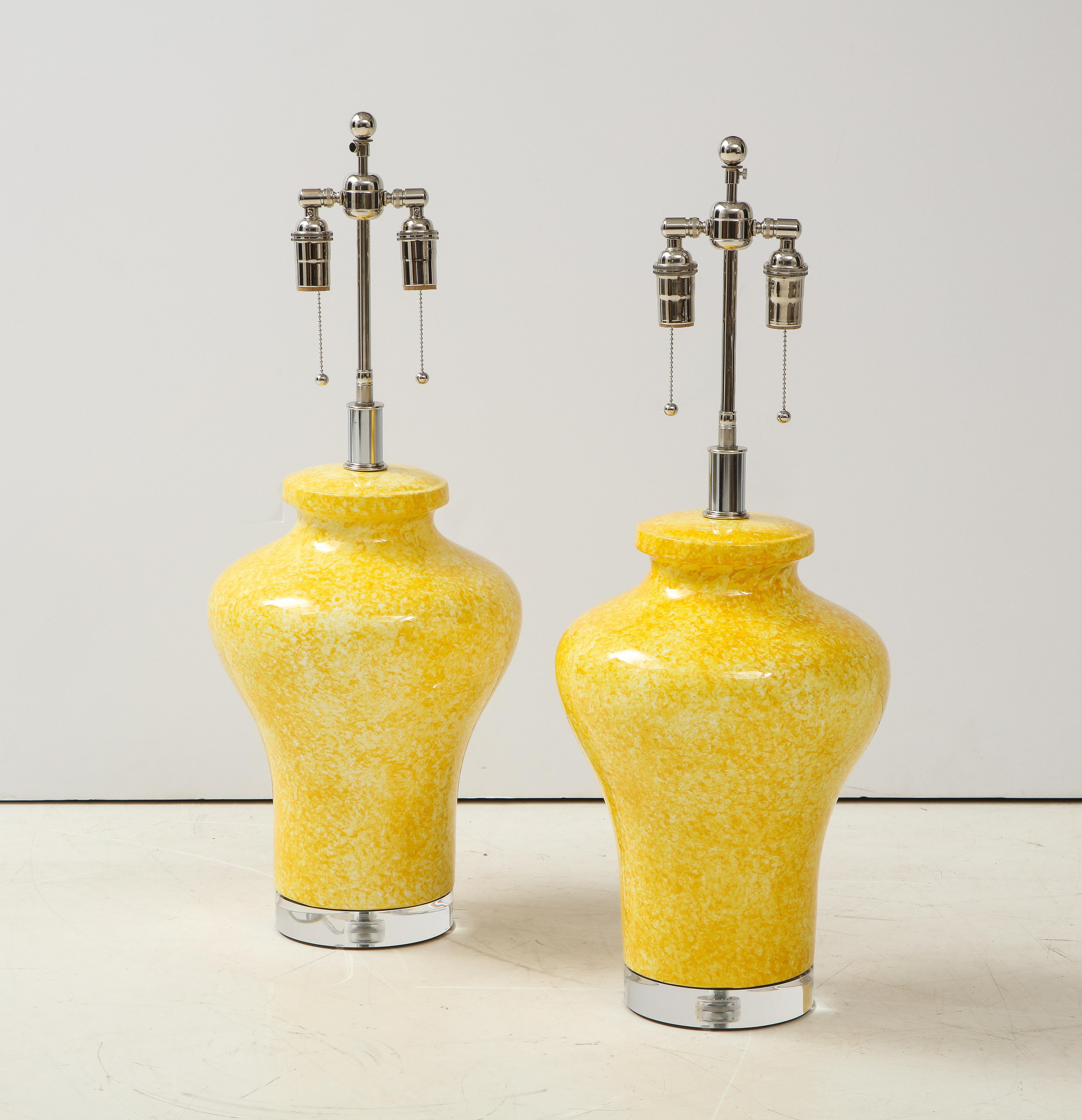 Pair of large ceramic lamps in a canary yellow glazed finish.
The lamps are mounted on 1.25