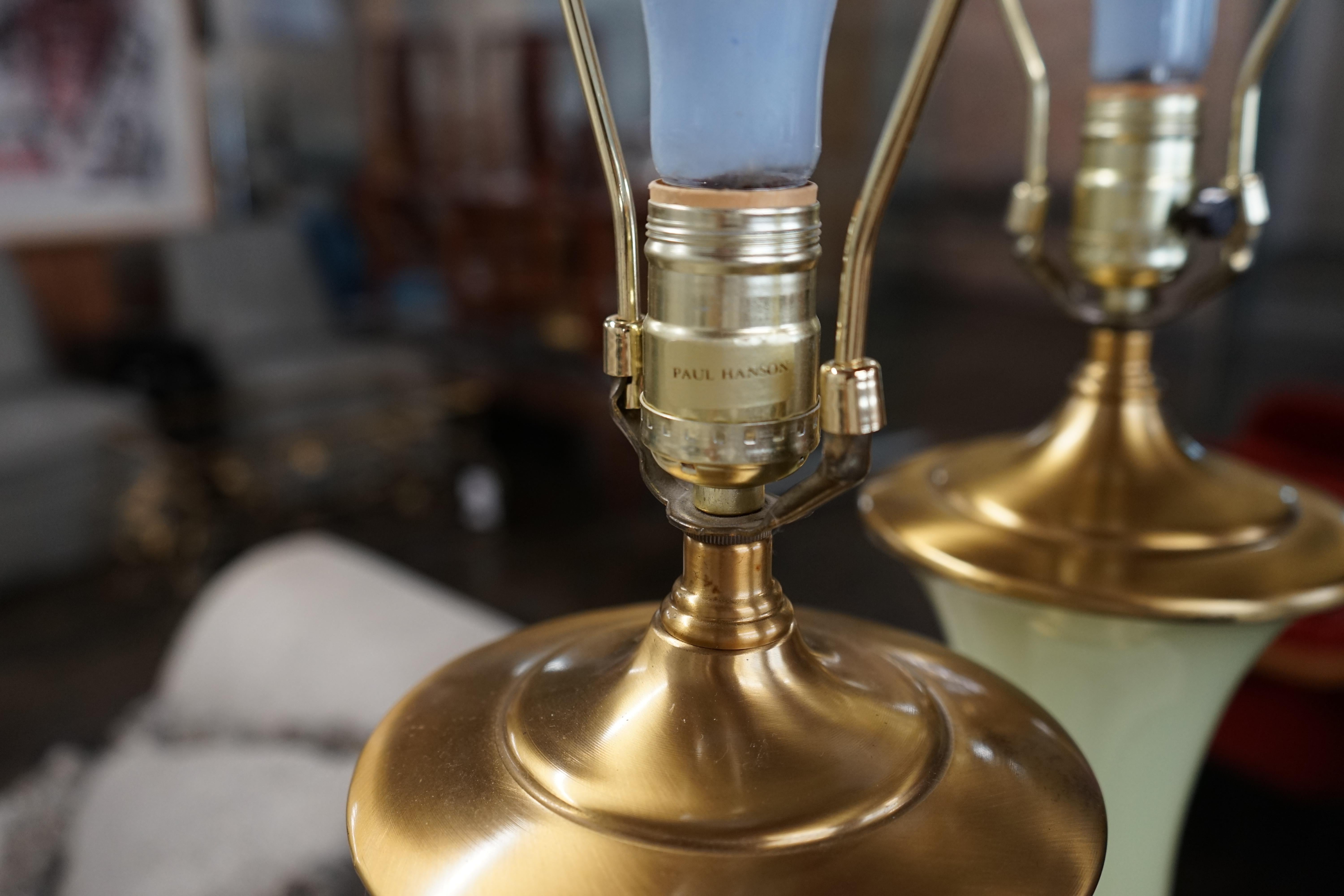 Lovely pair of Paul Hanson bronze mounted Vaseline glass lamps done in the Hollywood Regency style. The glass is almost a chartreuse color (somewhere between a light yellow and a light green).  They embody the glamour and luxurious materials