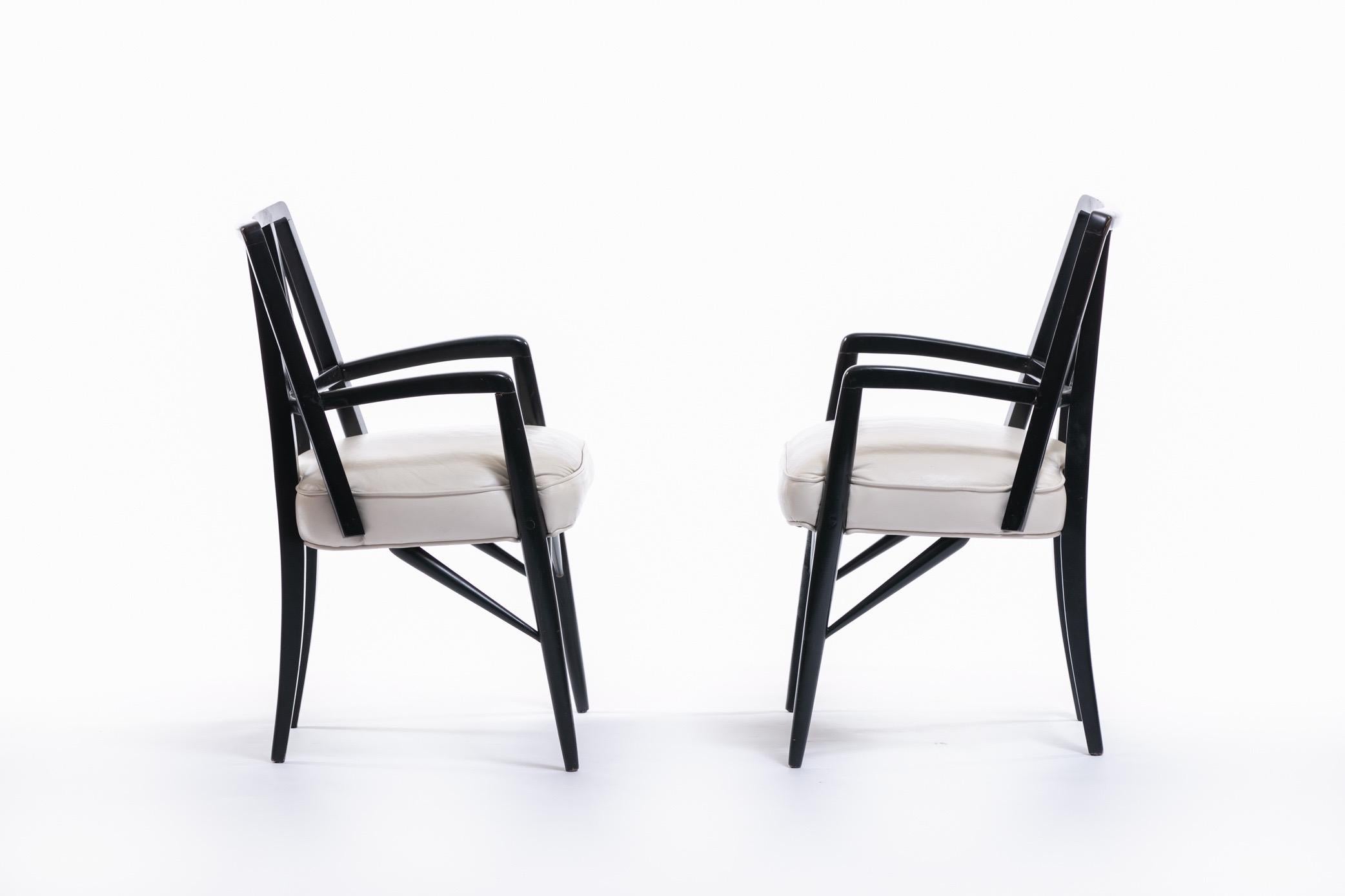 A favorite of Paul Laszlo, these chairs were featured in design projects for the Brentwood Country Club (see photo), Mr. Laszlo's personal residence, and the Fausto M. Ricci family. Original black lacquered wood and ivory leather seat. The arm