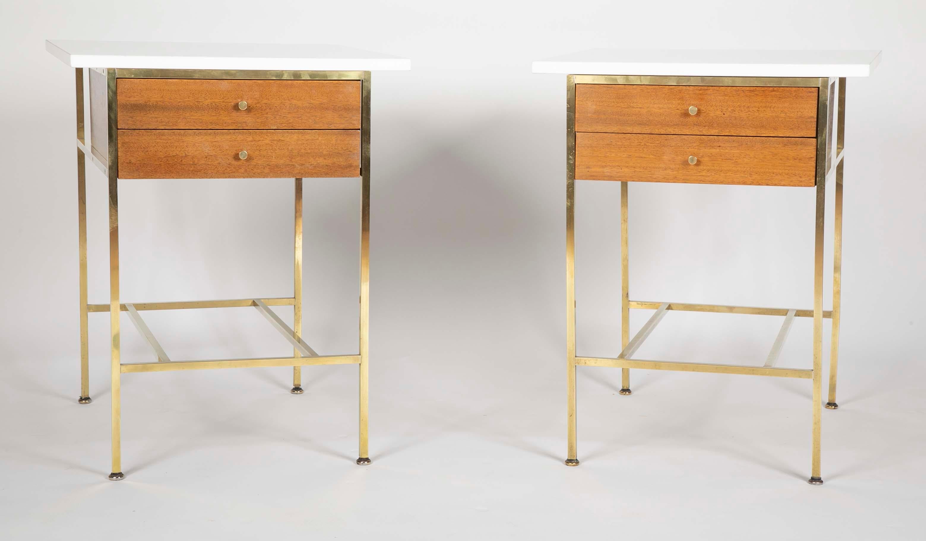 A pair of restored Model 8712 side tables. Designed by Paul McCobb for Calvin Furniture. The tables have Vitrolite (milk glass) tops. Period Travertine Marble tops also available in place of the Vitrolite tops.