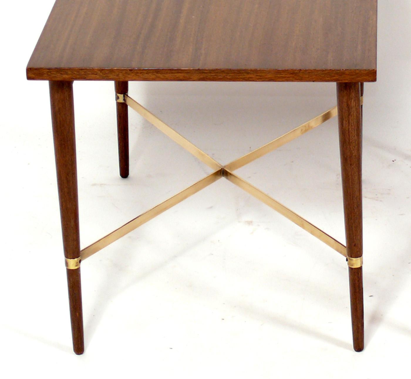 Pair of Mid Century Brass X Base End Tables, designed by Paul McCobb, American, circa 1950s. They are being refinished and can be completed in your choice of color. The price noted includes refinishing in your choice of color. The brass elements