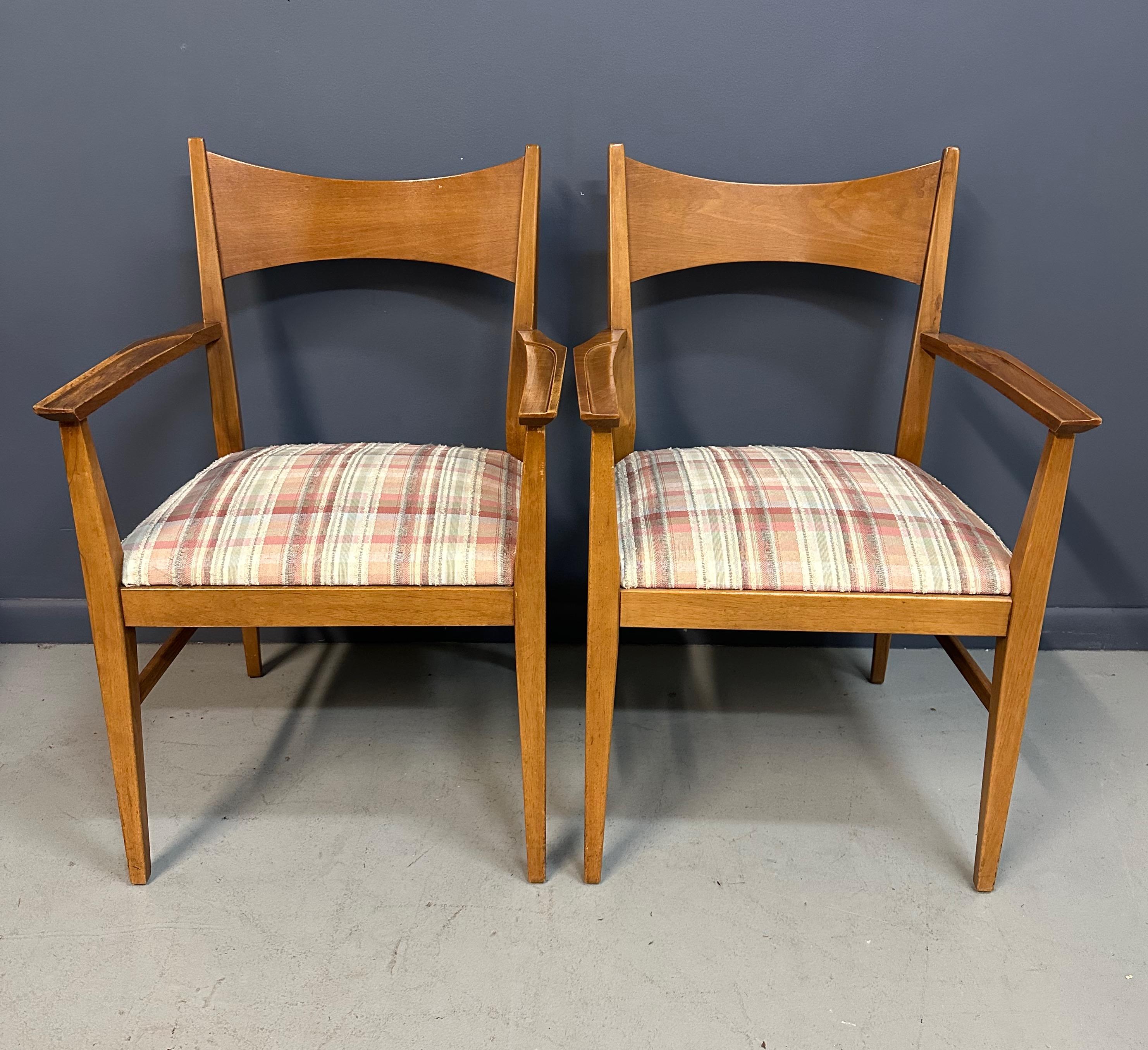 Elegant pair of mid-century modern armchairs designed by Paul McCobb for Calvin Furniture. Crafted from warm mahogany, these chairs feature McCobb’s signature clean lines, gently curved backs, and tapered legs, showcasing his refined minimalist