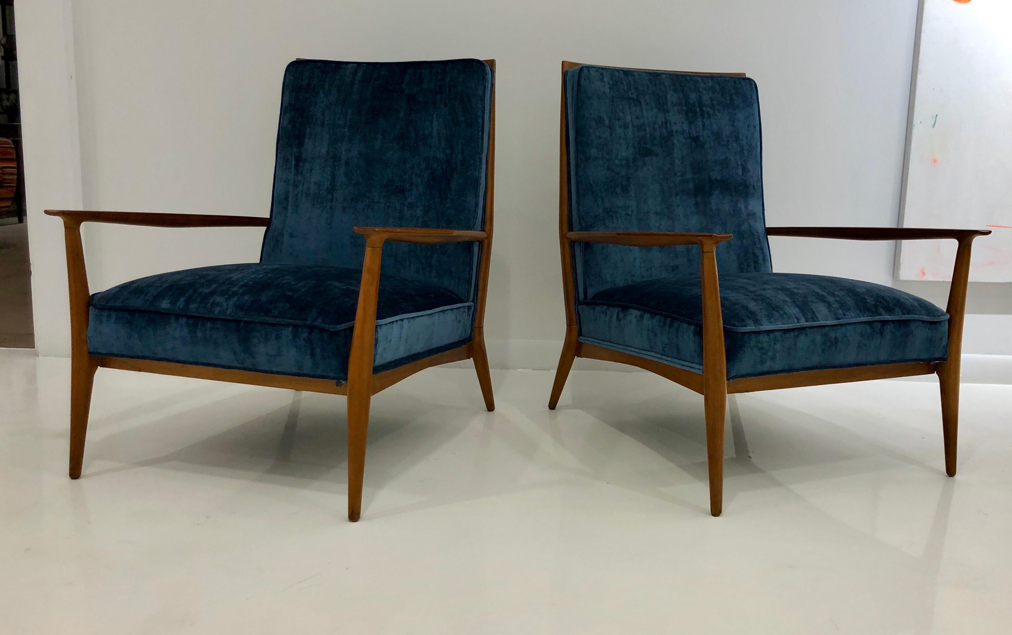 Classic and somewhat rare pair of armchairs in walnut with new silk upholstery. Great lines and nicely proportioned. Newly refinished.