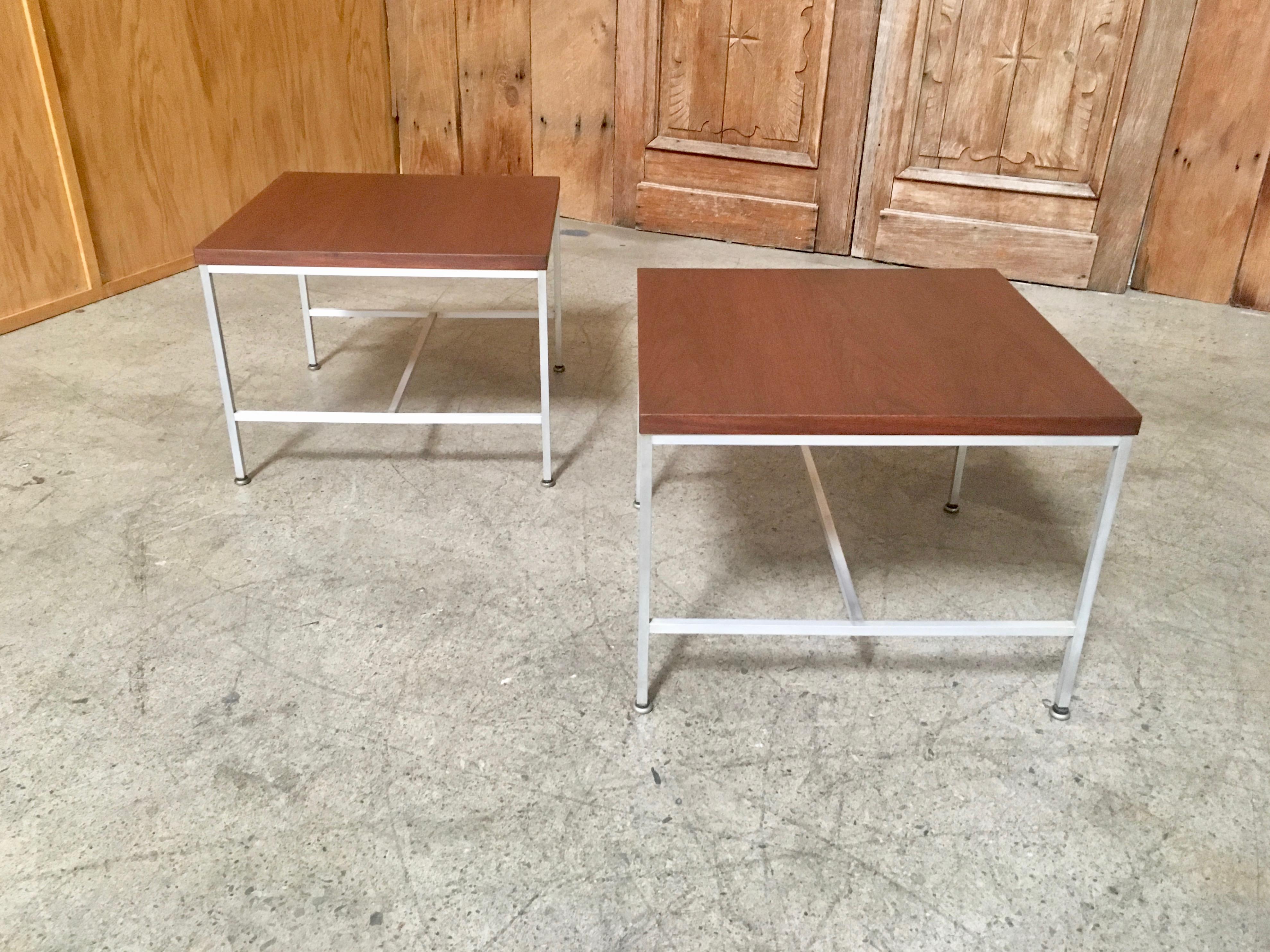 A pair of walnut tops with aluminium base side tables from the Erwin collection designed by Paul McCobb for Calvin furniture.