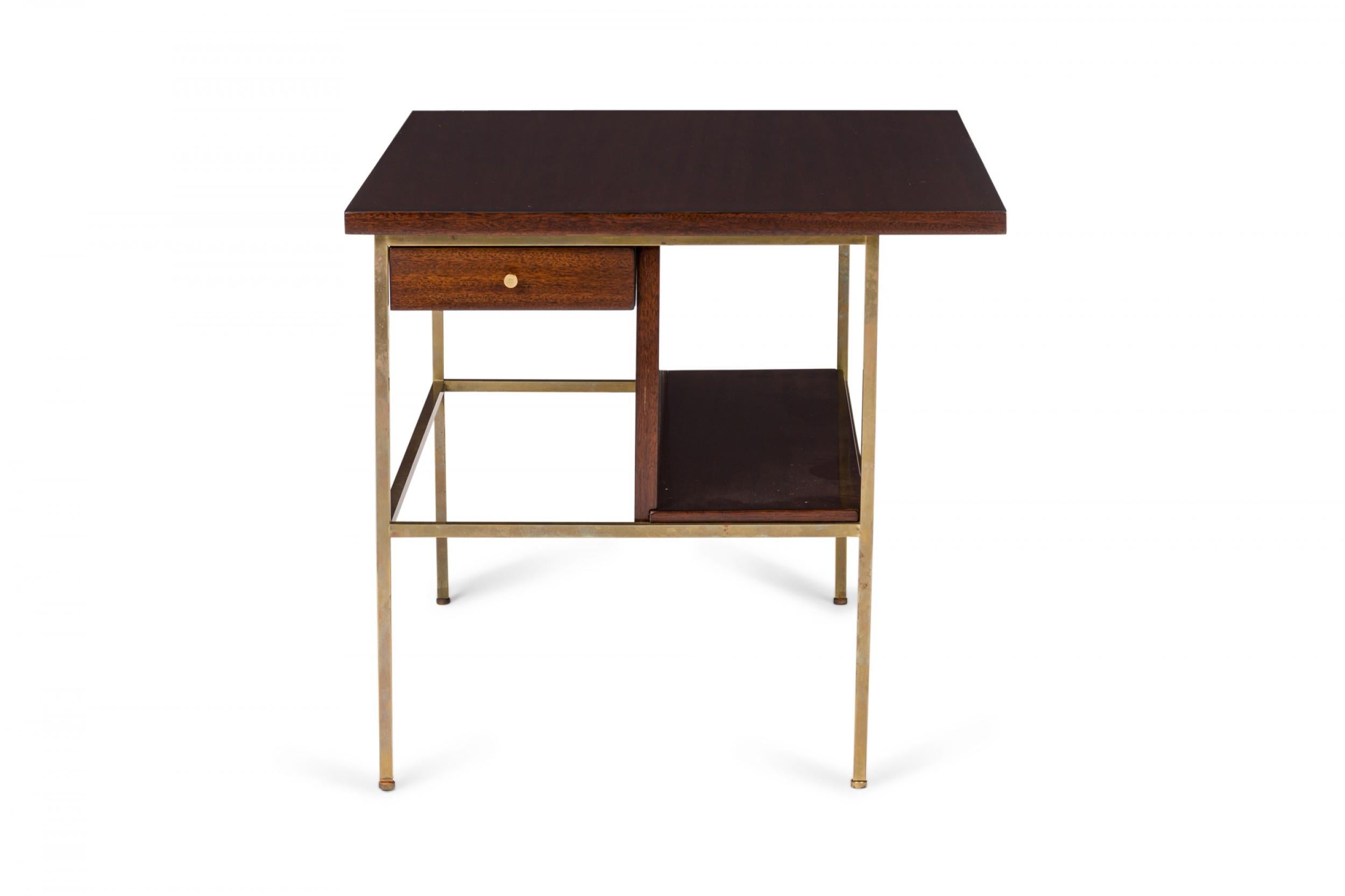 PAIR of American Mid-Century cantilever design end / side tables with rectangular walnut tops above a small drawer with brass drawer pulls, flanked below on the opposite side by an open shelf, supported by a brass frame with rectangular stretcher