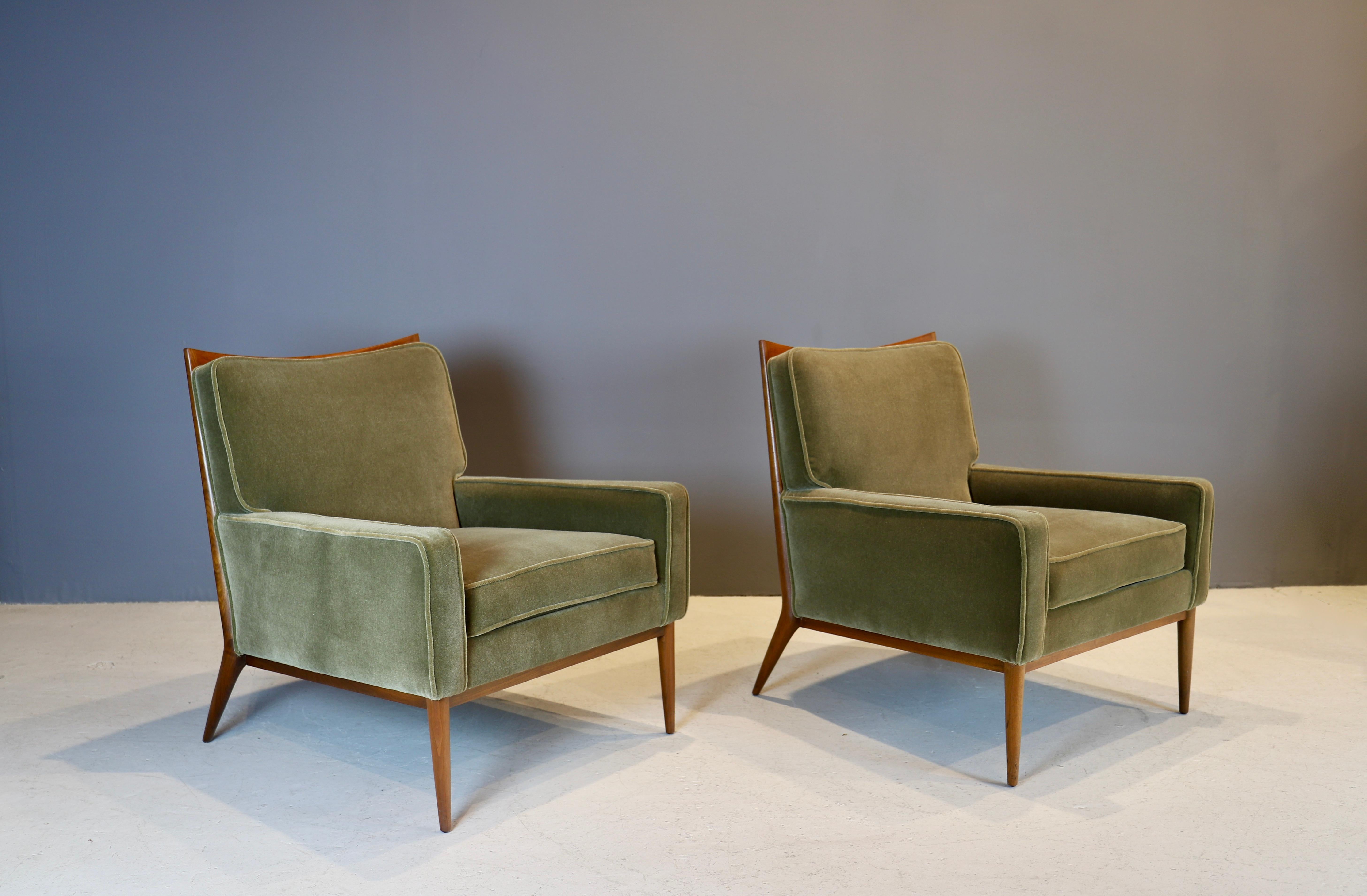 Iconic pair of walnut lounge chairs, designed by Paul McCobb and produced by Calvin, NY, 1950s.
Frames have been refinished in natural and complimented by moss green mohair upholstery.
Original labels underneath.
By far McCobb's most elegant