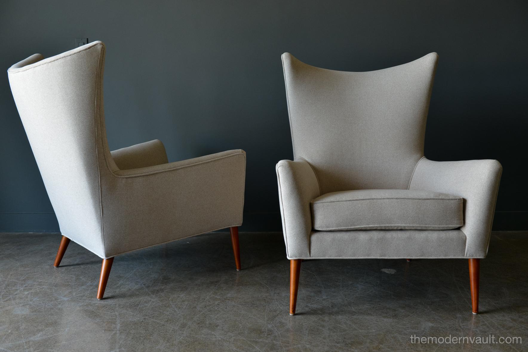 Pair of Paul McCobb Model 3015 wingback lounge chairs, circa 1955. Rare matching pair professionally restored in a rich, high quality oatmeal/light tan felt poly. Fabric exceeds 60,000 double rubs using Wyzenbeek method. Gorgeous design, this chair