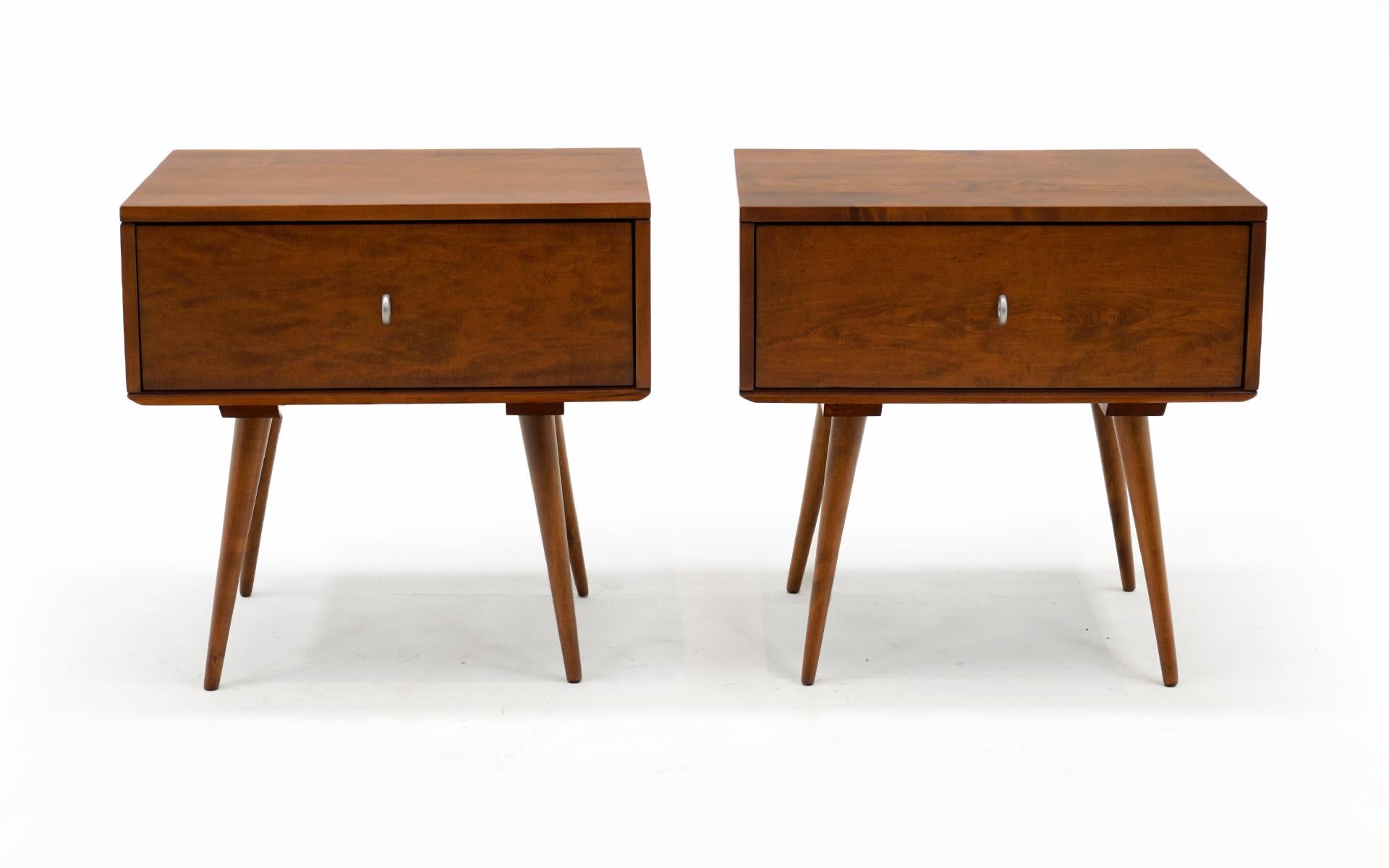 Pair of Paul McCobb nightstands or side tables in medium to dark stained birch. These are part of McCobb's Planner Group for Winchendon Modern, 1950s. Each has one single drawer with nickel pulls. Expertly refinished and ready to use.
