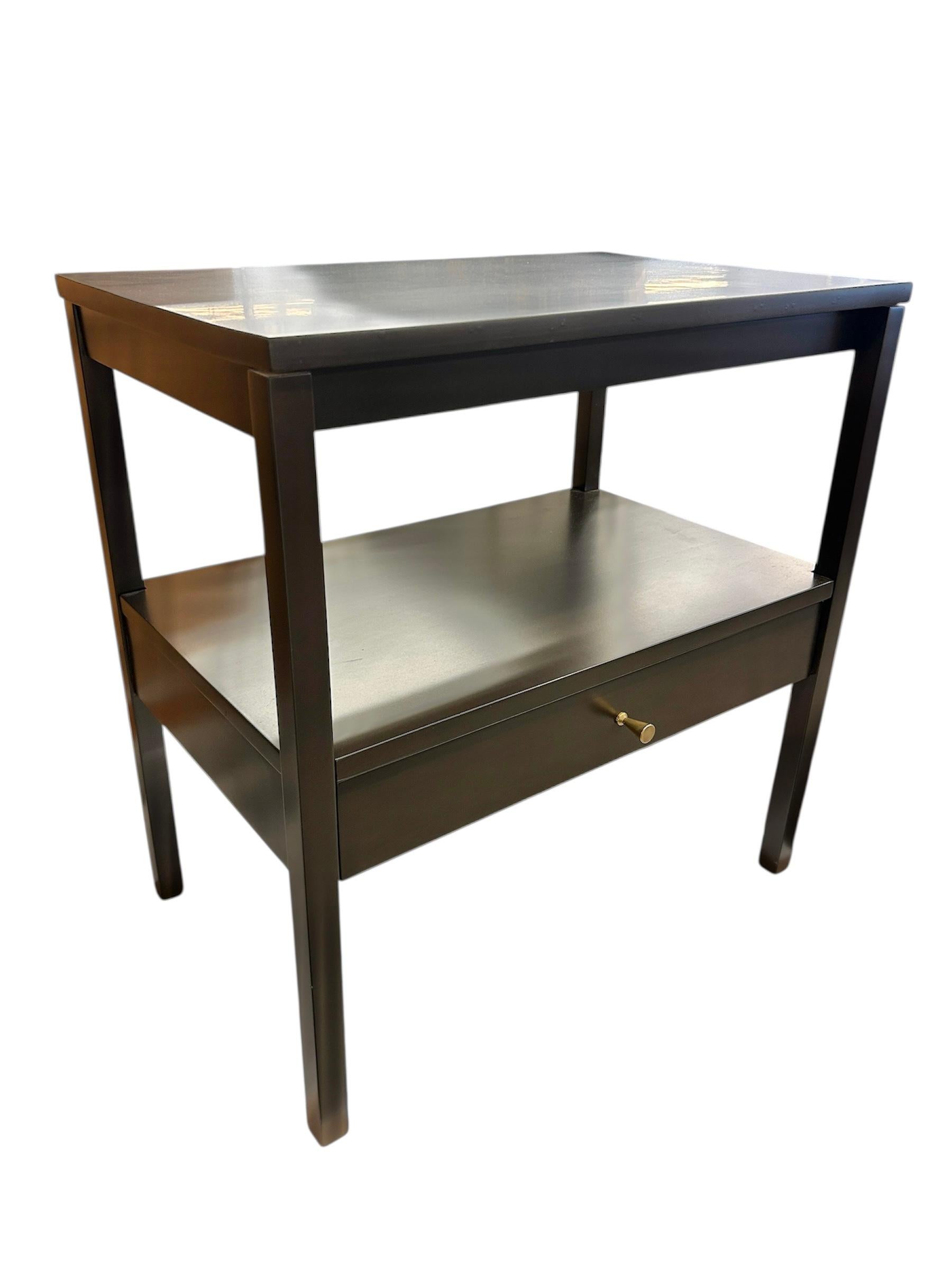 A very special pair of iconic Paul McCobb end tables/night stands. These mid century modern pieces have been restored to their original finish. They are constructed in maple with a dark walnut stain. The hardware is original. Stylish and highly
