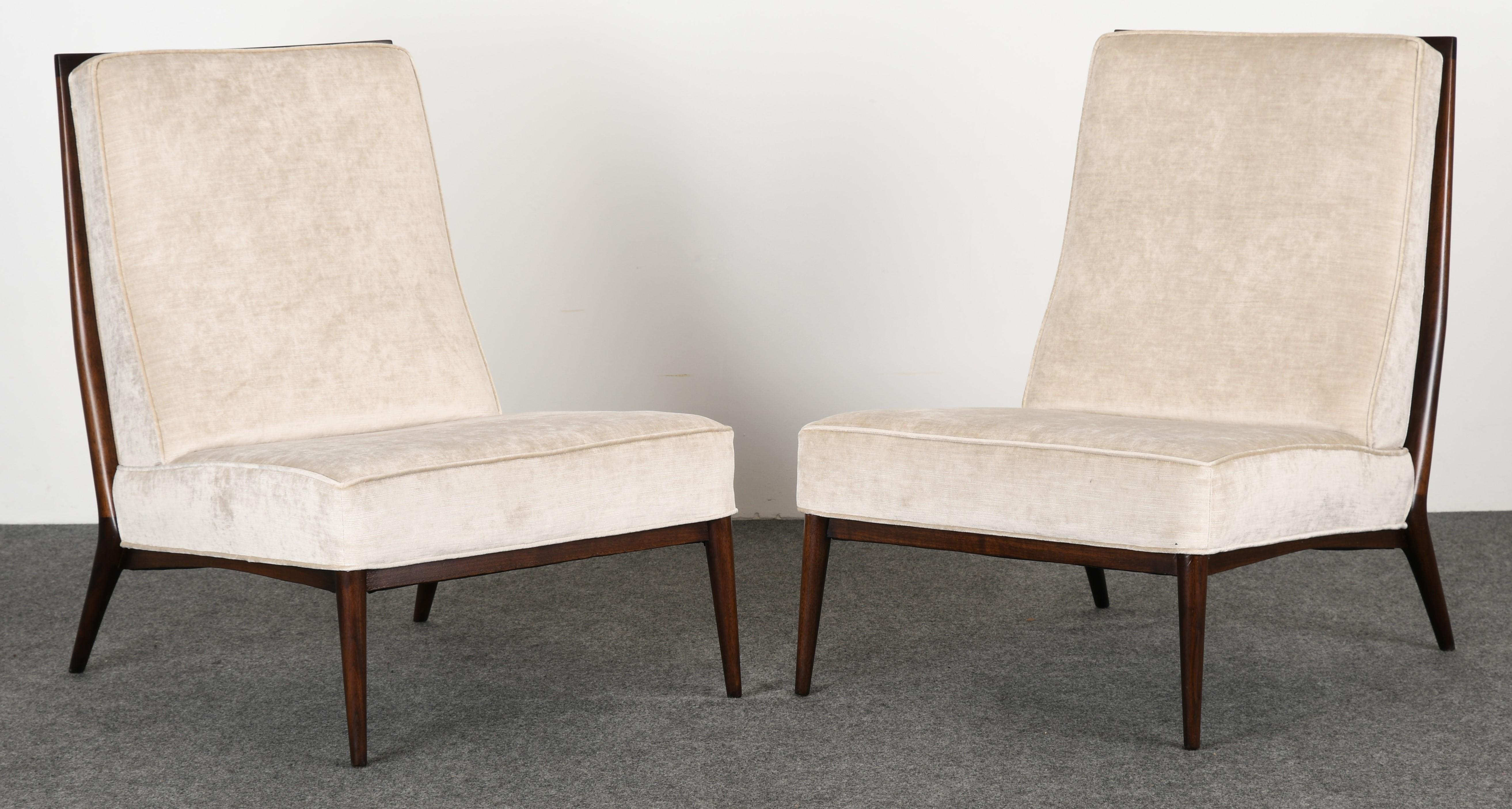A newly upholstered pair of Paul McCobb Model 5000 slipper chairs for Directional. Upholstered in a Holly Hunt neutral velvet. The chairs are stained in an espresso walnut finish. The chairs are structurally sound and in excellent condition.