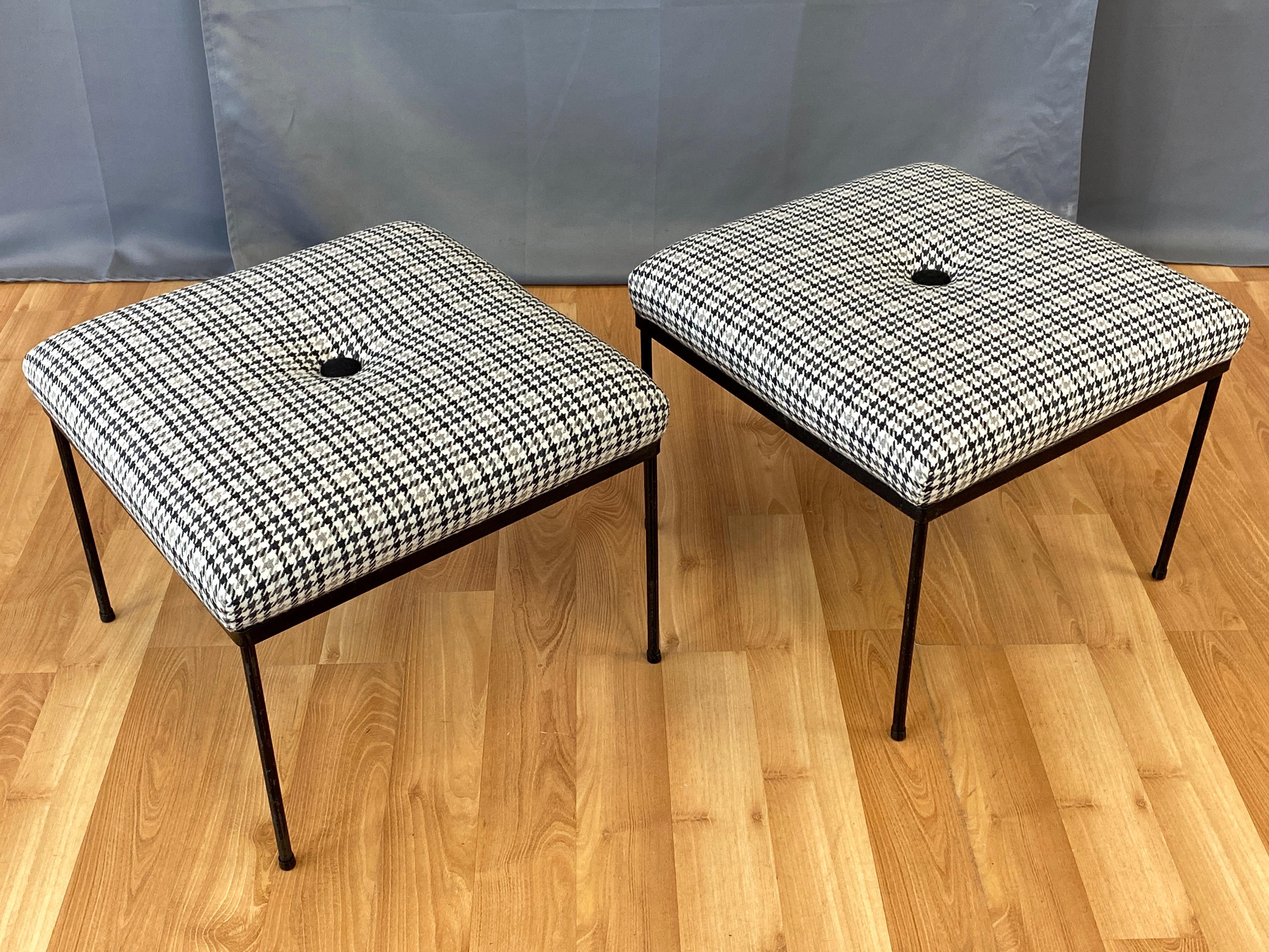 A smartly dressed pair of 1950s Mallin Furniture McCobb-style ottomans with black frames and new houndstooth plaid tufted upholstery.

Minimalist iron frame with slender rod legs on original plastic feet. Semi-gloss black lacquer over matte black