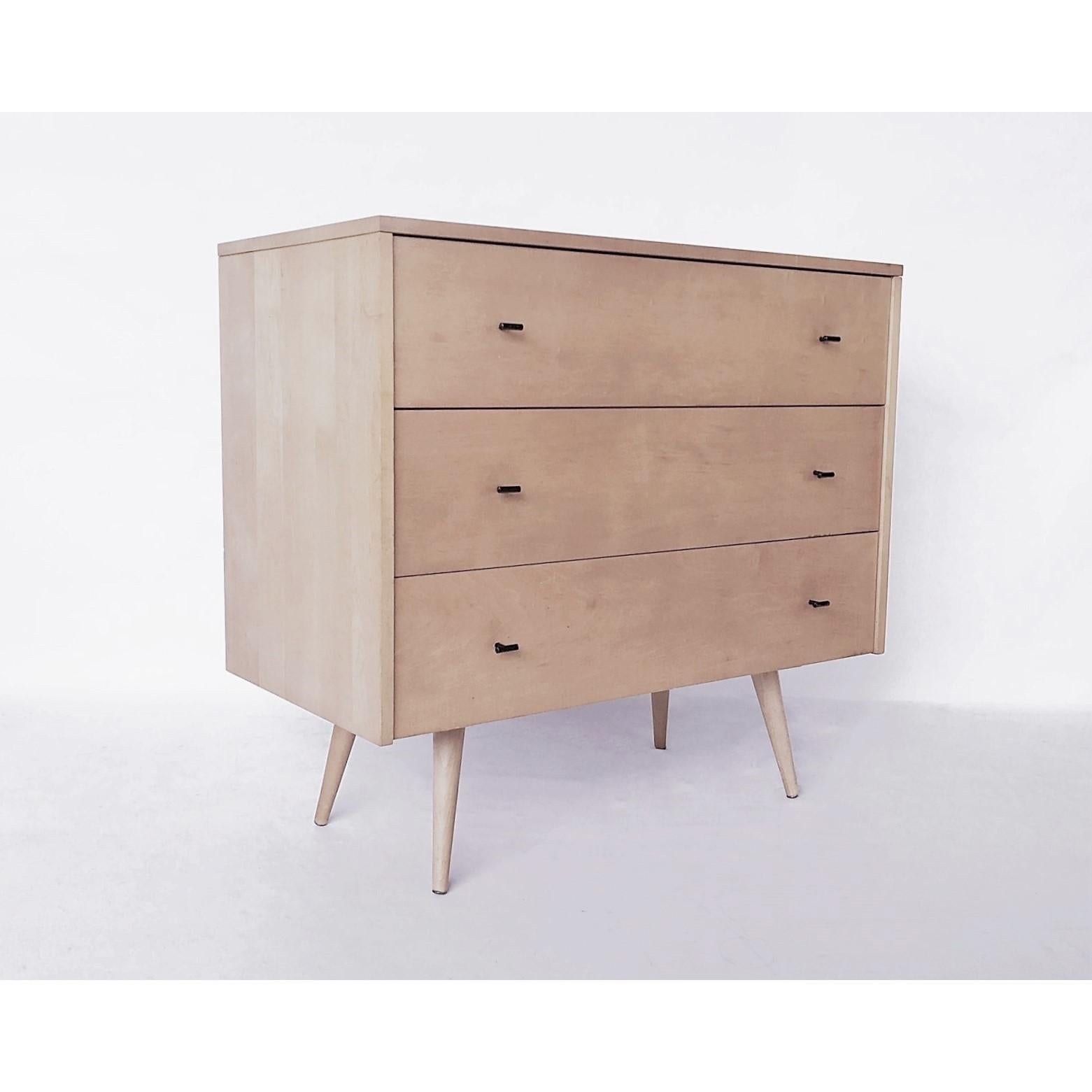 These matching pair of solid maple three-drawer chests designed by Paul McCobb as part of his Planner Group. The handles are 