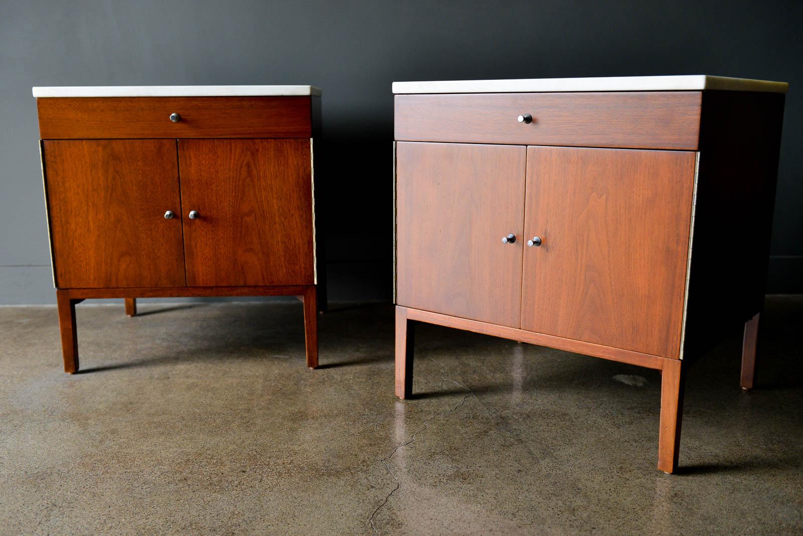 Pair of Paul McCobb for Calvin Furniture walnut and marble nightstands or end tables, circa 1960. Beautiful walnut grain restored in very good condition with original white marble tops. Inner shelf is adjustable or removable and drawers are lined in