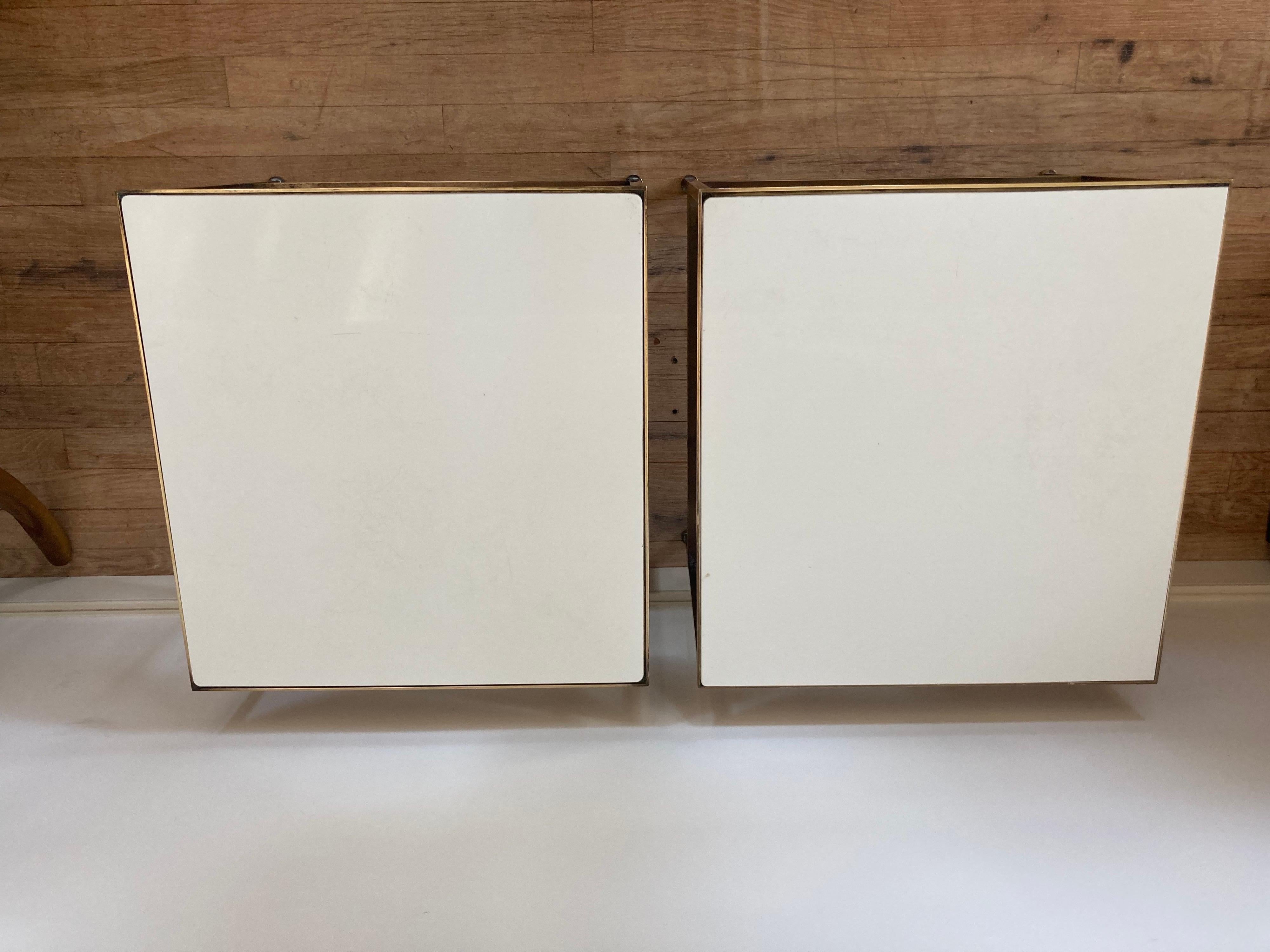 Pair of brass framed white glass or vitrolite top tables design by Paul McCobb for Calvin.