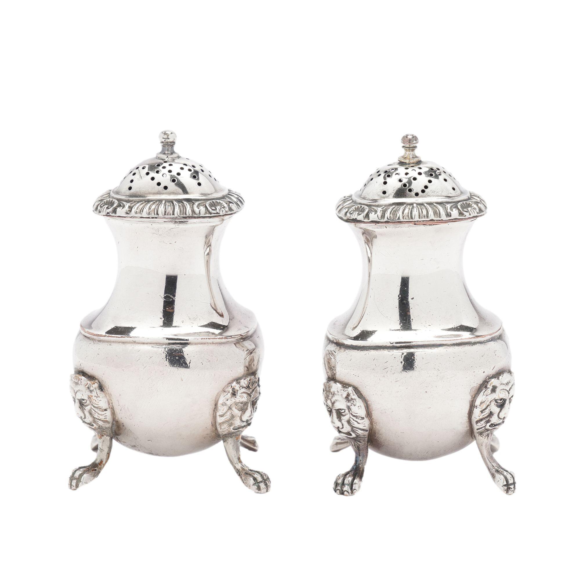 Pair of Sheffield silver pear shaped pepper castors with pierced tops and gadrooned edges. The castors rest on four lion’s paw feet which originate from four applied lion’s mask mounts.

Impressed on the underside: Makers monogram shield with 