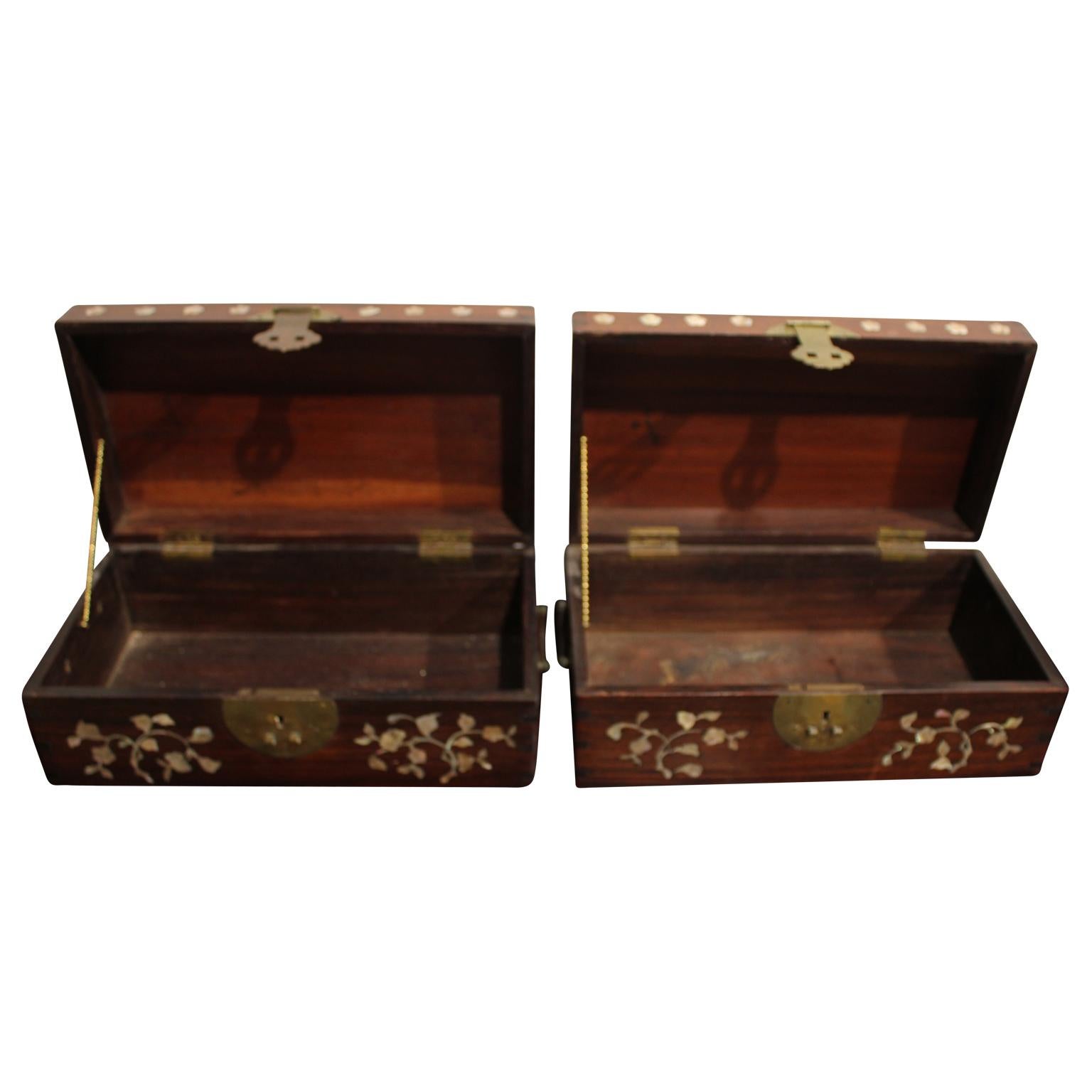 Pair of inlaid boxes with blossoms. The pair of boxes have the original slide locks. The symbol on the top of the box is similar to the Chinese and Japanese symbol of wealth and prosperity.
Dimensions are of one box.