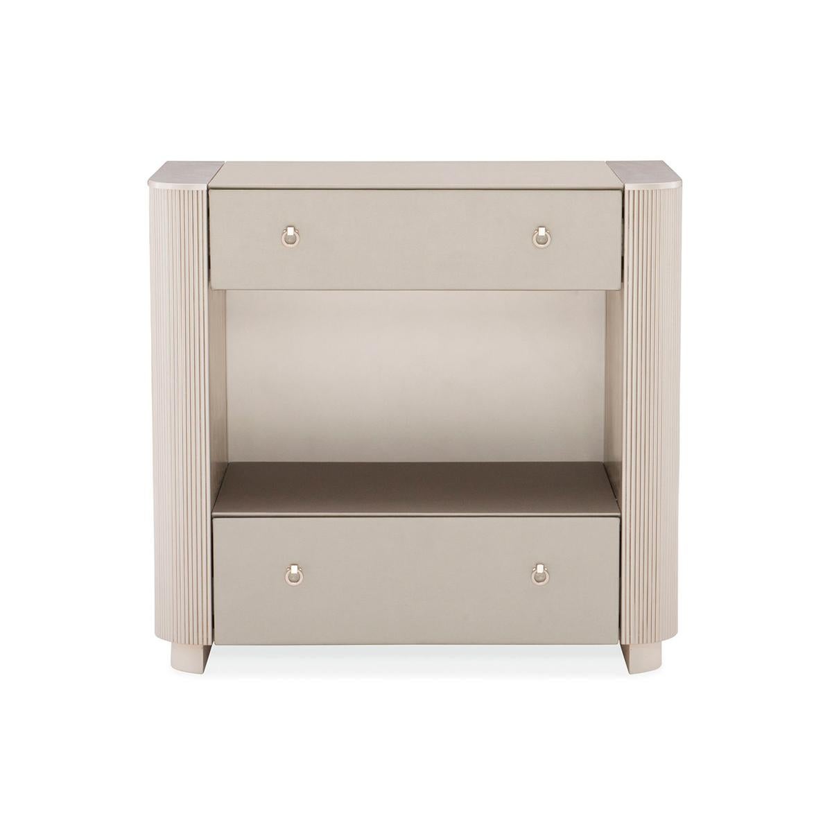 Cap the sides of your favorite bed with elegant nightstands that are just as dreamy. This stunning bedside piece boasts a fashion-forward design with a softly rounded profile accentuated by exquisite fluted sides and vinyl wrapped drawer