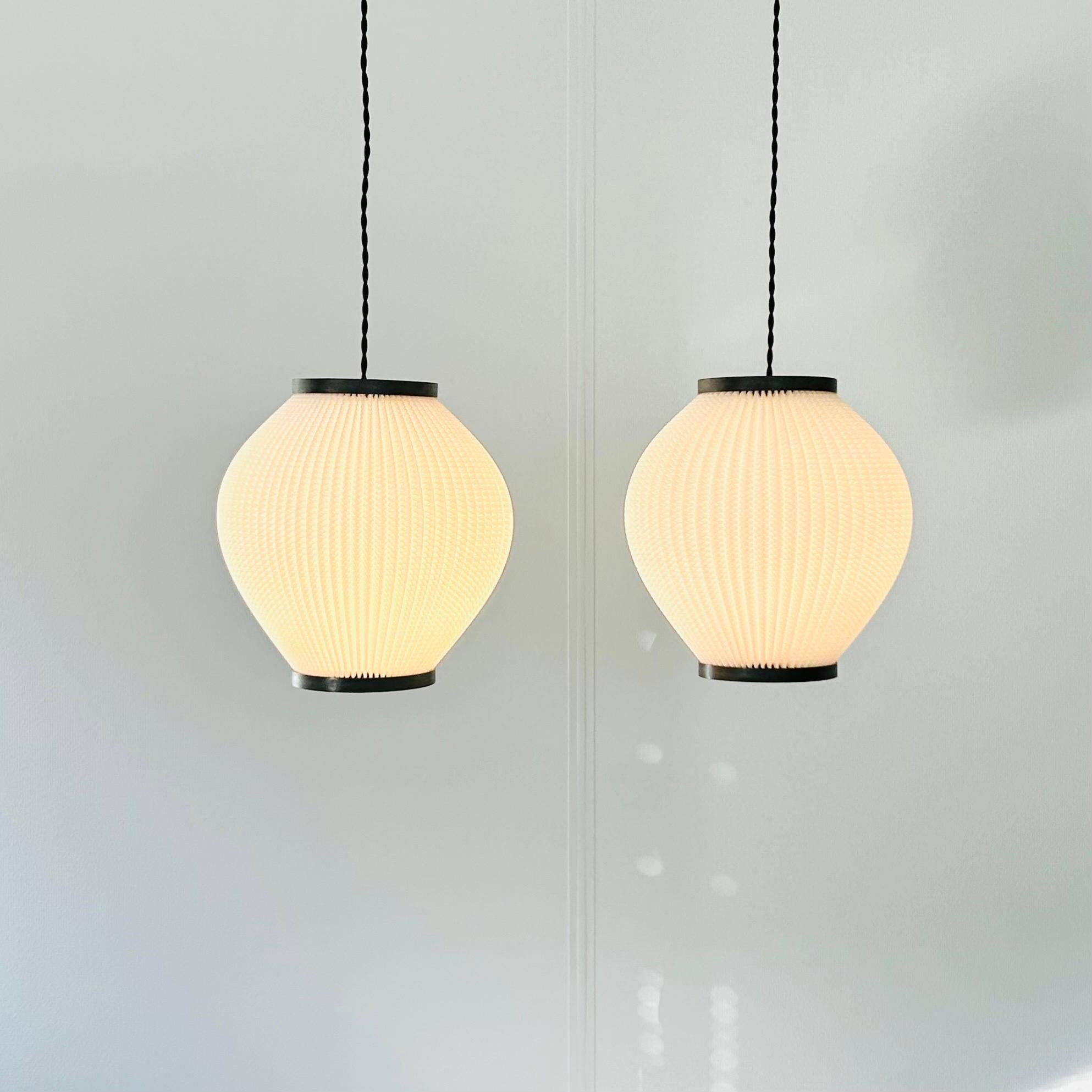 A pair of pendant lights designed by Lars Ejler Schiøler for P.J. Høyrup in 1950s, later Høyrup Lightning. The style is called 'Pearlshade' and is one of the icons of Lars Ejler Schiøler. Beautiful, architectural lamps in antistatic plastic.

The