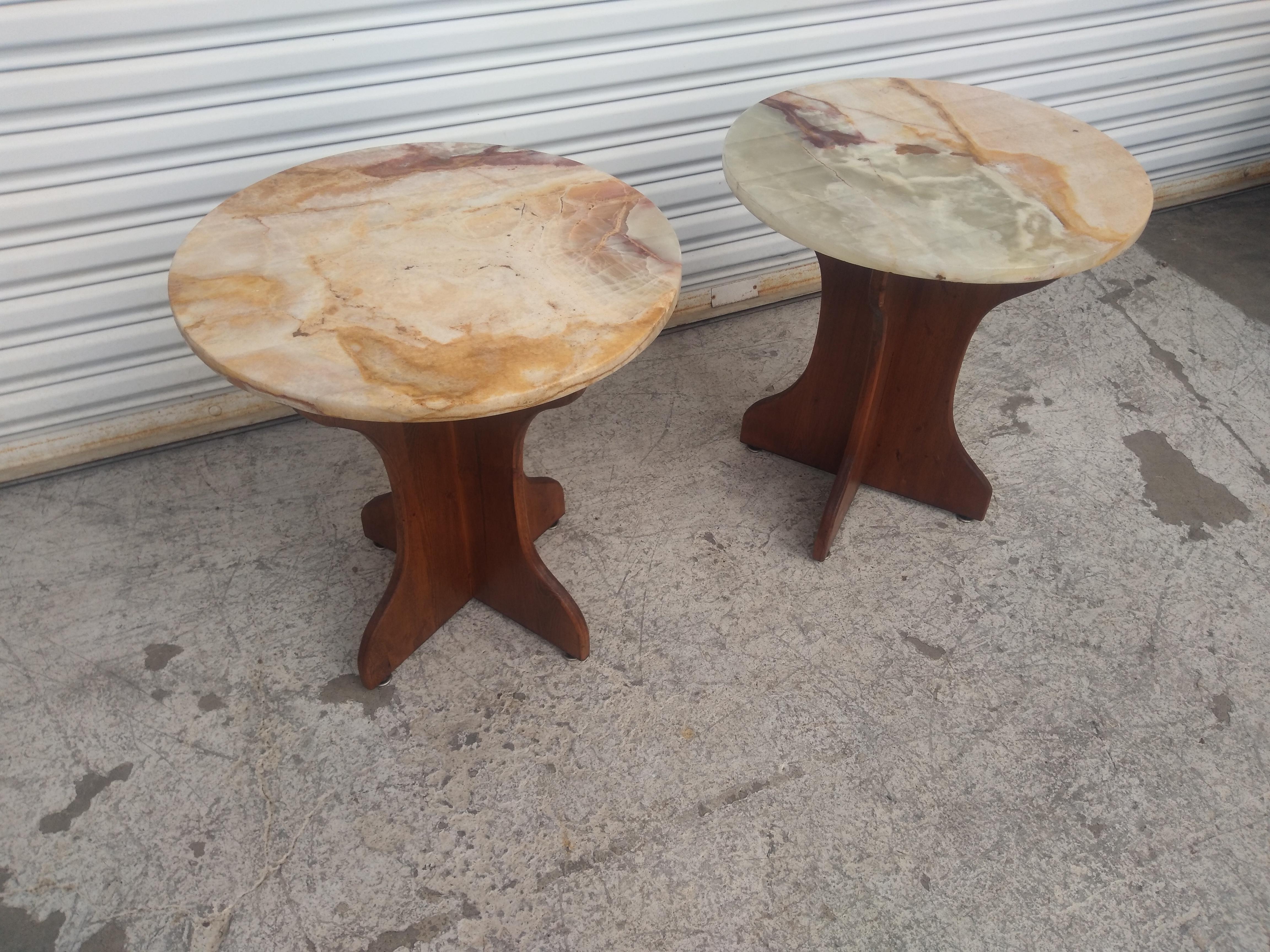 This is a nice pair of end tables. They have onyx tops that rest on pedestal bases. The bases are made of walnut and have a x-base. They are quite attractive and would make a nice addition to any home.