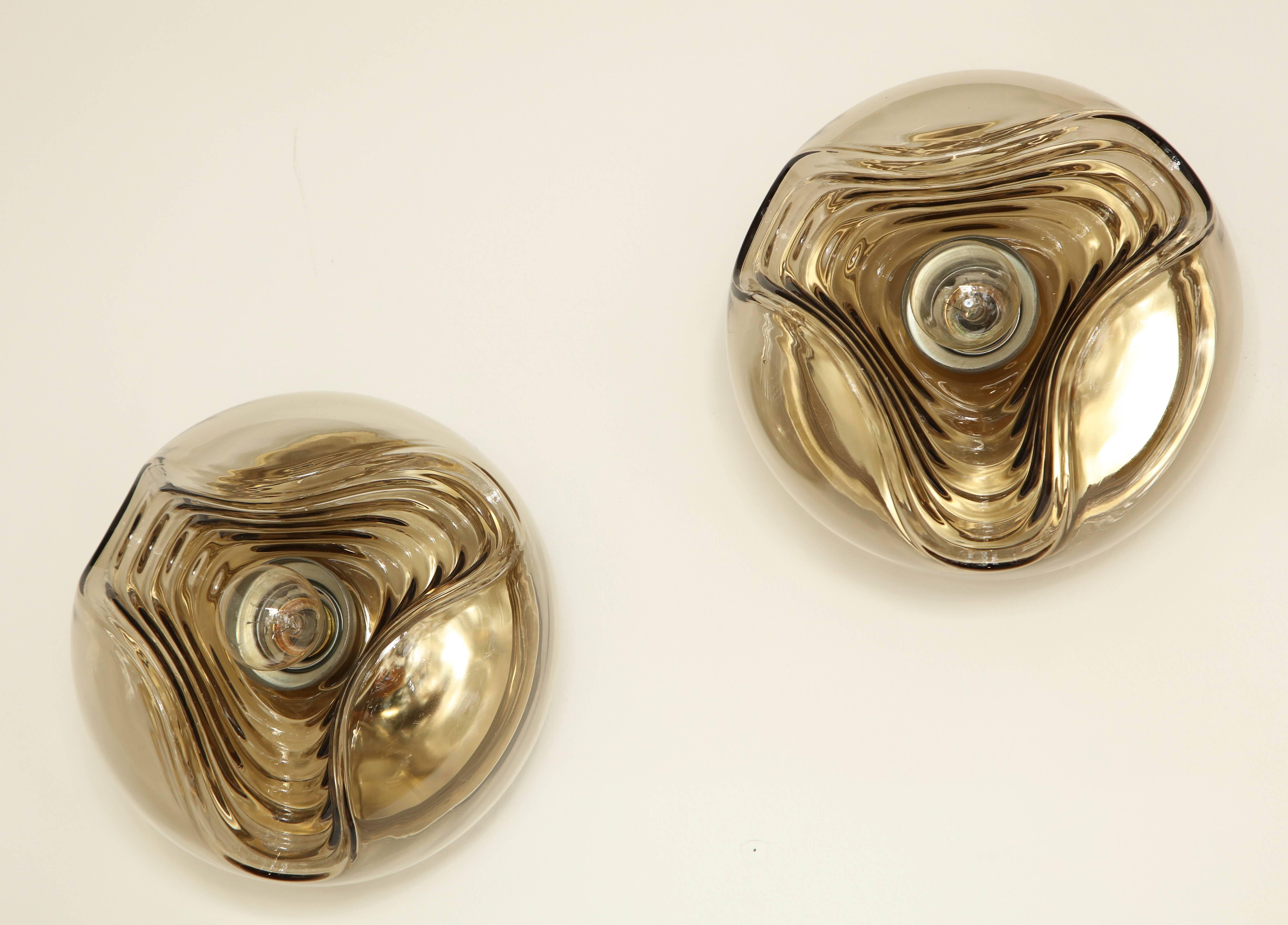 Wonderful pair of modernist Space Age smoked glass sconces by Peill and Putzler.
The sconces have been newly rewired for the US with a single light source.