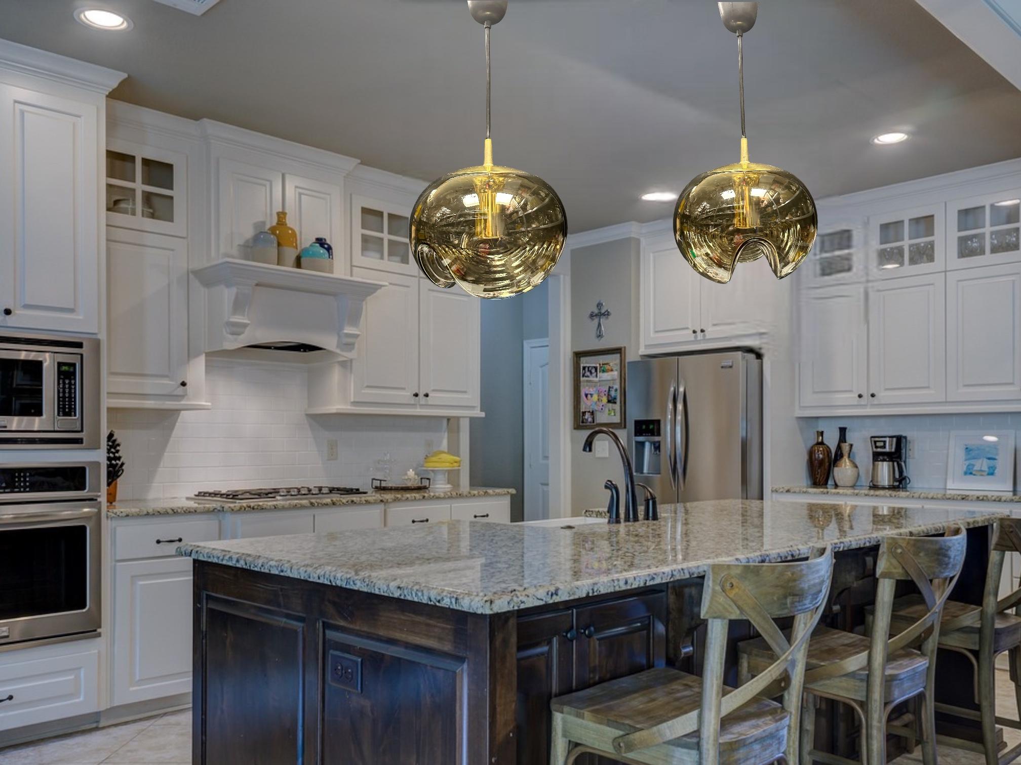 A nice pair of Peill & Putzler amber or smoked glass wave pattern Pendant lights with brass hardware. Made by Peill and Putzler Germany, design by Koch and Lowy. Each Pendant requires one European E27 Edison bulb, up to 75 watts. Glass part measures