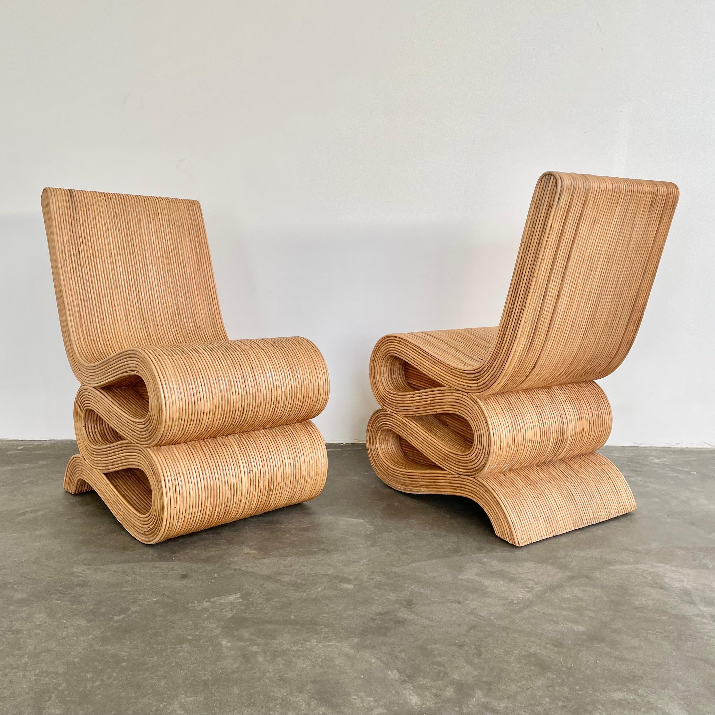 Fantastic pair of zig zag rattan chairs in the style of Frank Gehry, circa 1970s. These chairs are an amazing example of pencil reed design with long reeds flowing side by side in a beautiful pattern. These beautiful chairs give the appearance of a