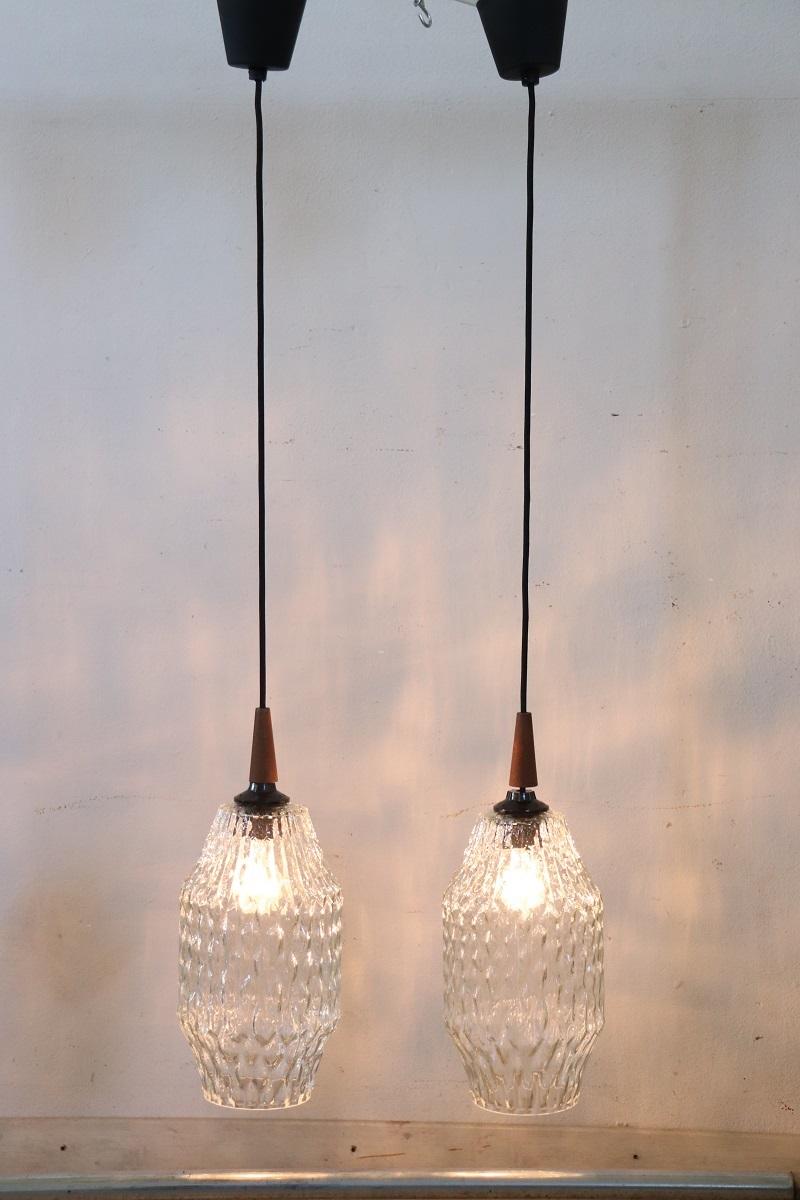 This pair of 1960s Italian ceiling lamps, while not having any brands or signatures, boasts quality in materials and design. Made of transparent Murano glass with a particular decoration that is inspired by the productions of Barovier.

The lamps