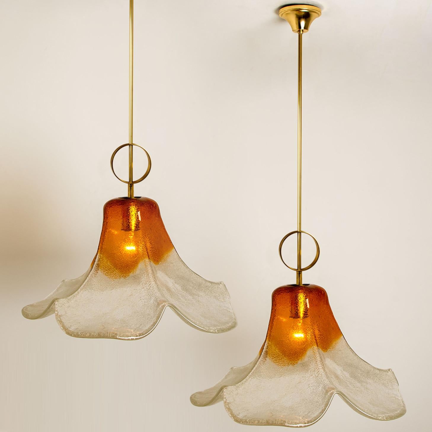 Pendant lamp model LS185 by Carlo Nason for Mazzega.
One large crystal clear and orange colored flower. This beautiful piece is made of thick handmade Murano glass.

We can deliver different kind of rods and cords (see images). Please notice the
