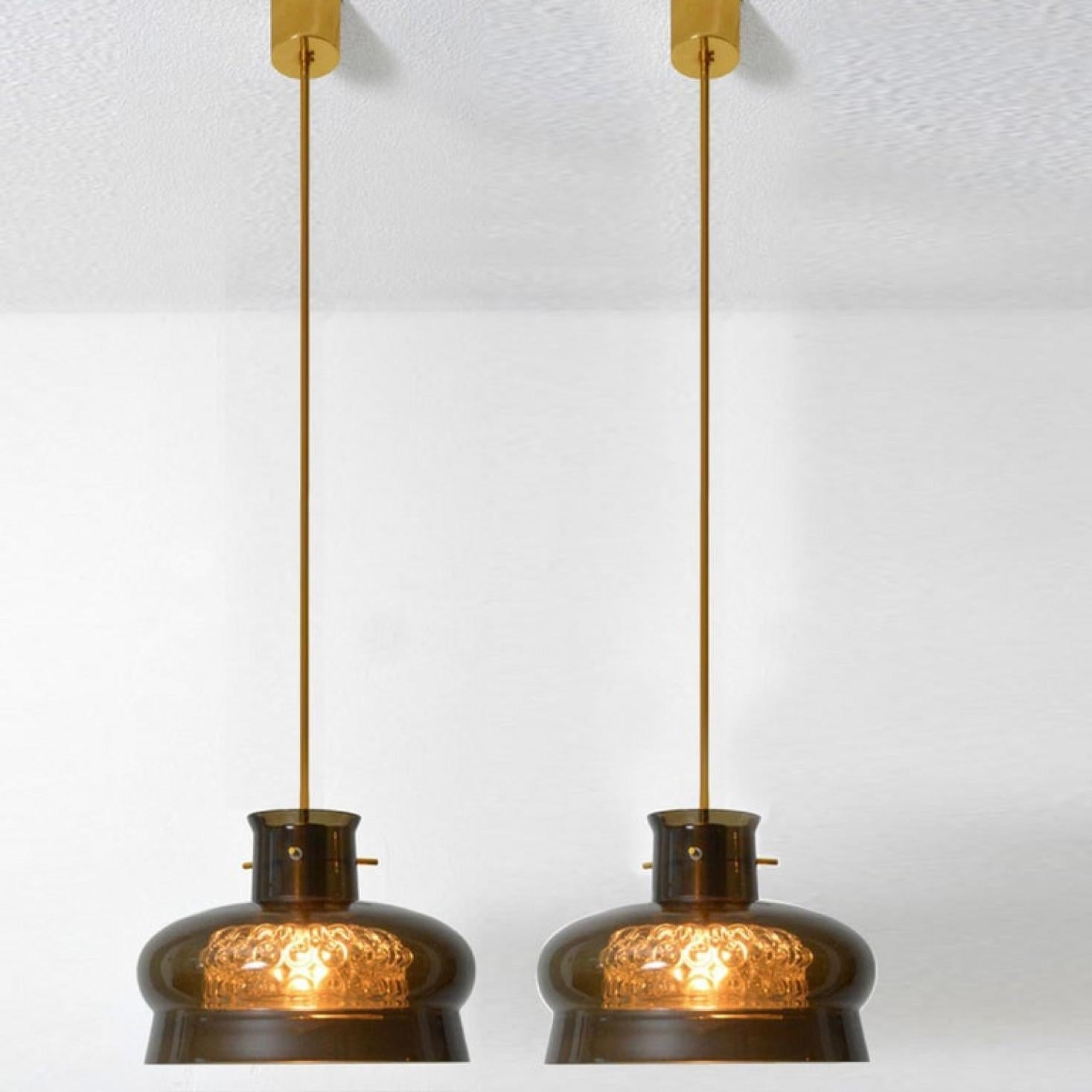 Brass Pair of Pendant Light by Carl Fagerlund for Orrefors in Brown and Bubble Glass For Sale