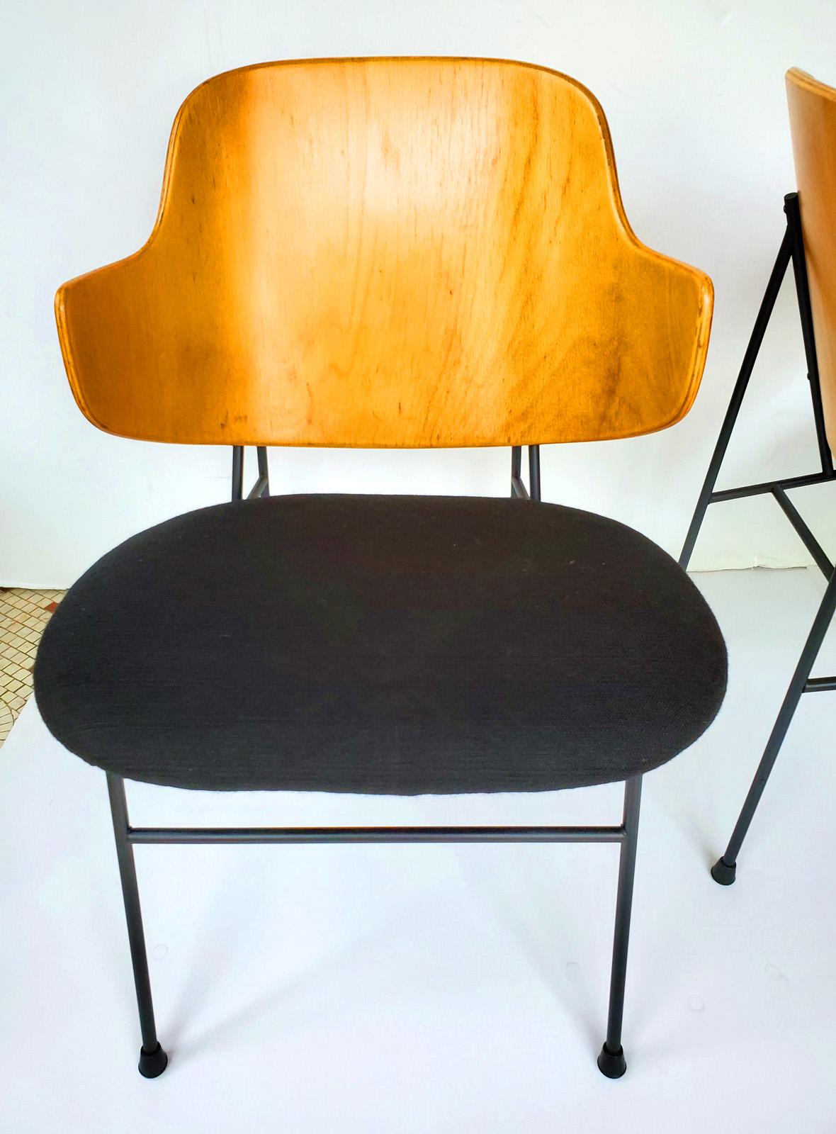Vintage pair of Classic Mid-Century Modern lounge chairs designed by
Ib Kofod -Larsen, Denmark. These were imported by Selig beginning, 1953.
Features bent plywood backs in birch, retaining nice patina. Seats are newly
upholstered. Iron frames