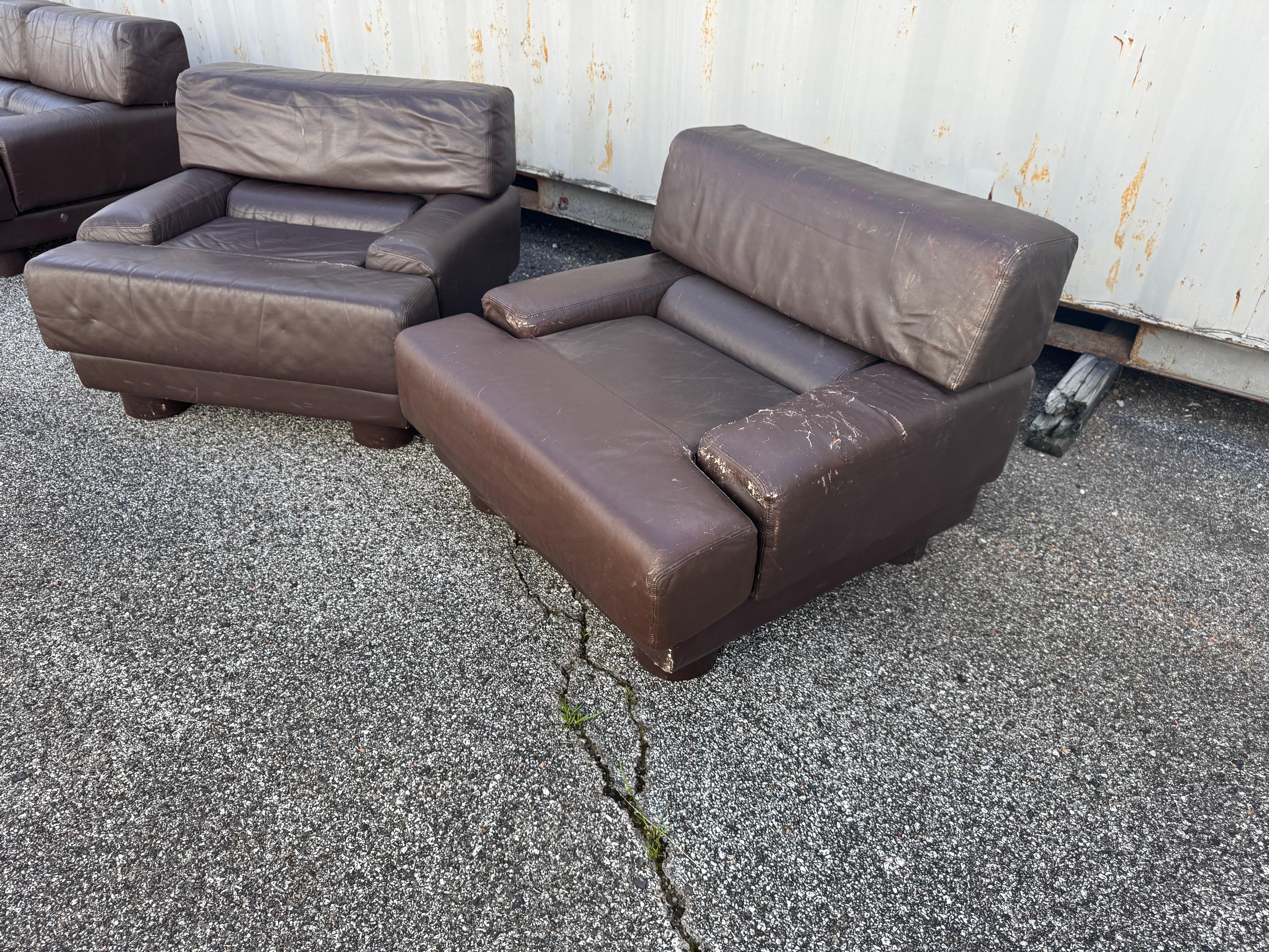 This is a rare pair of Percival Lafer Lounge chairs. The set is upholstered in a brown leather fabric and was made in Brazil. 

3 seat sofa and 2 seat loveseat also available. 

Needs to be reupholstered.
