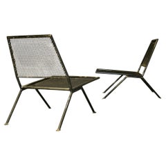 Pair of perforated metal armchairs