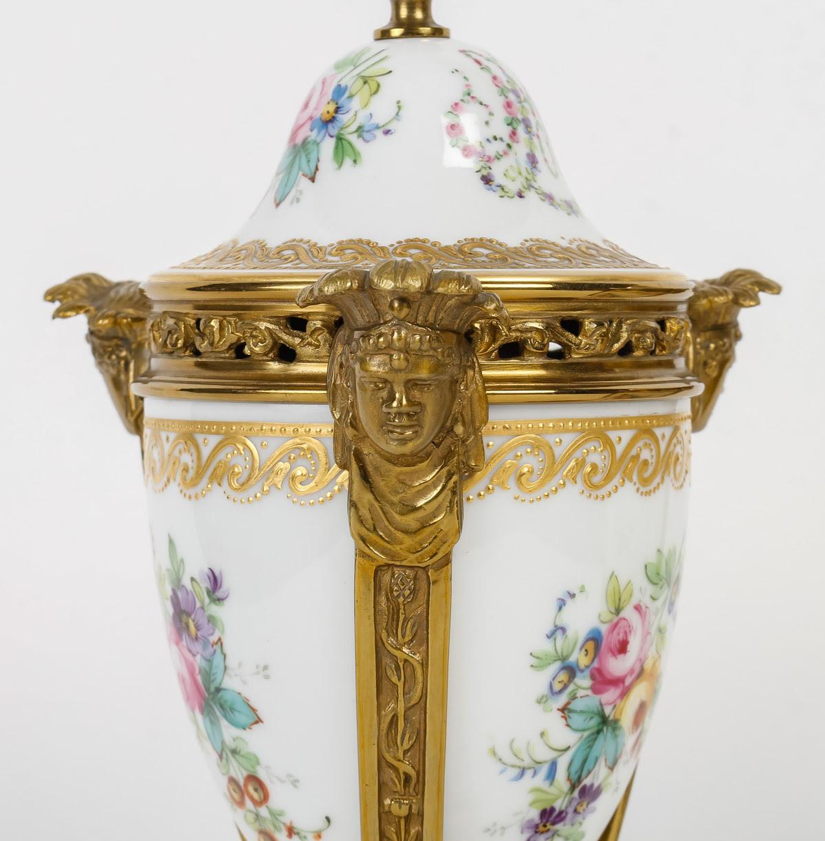 Pair of Perfume Burners from the Manufacture de Sèvres, Early 20th Century.

A pair of early 20th century gilt bronze and painted and gilt porcelain perfume burners from the Manufacture de Sèvres.
H: 26cm, d: 12cm