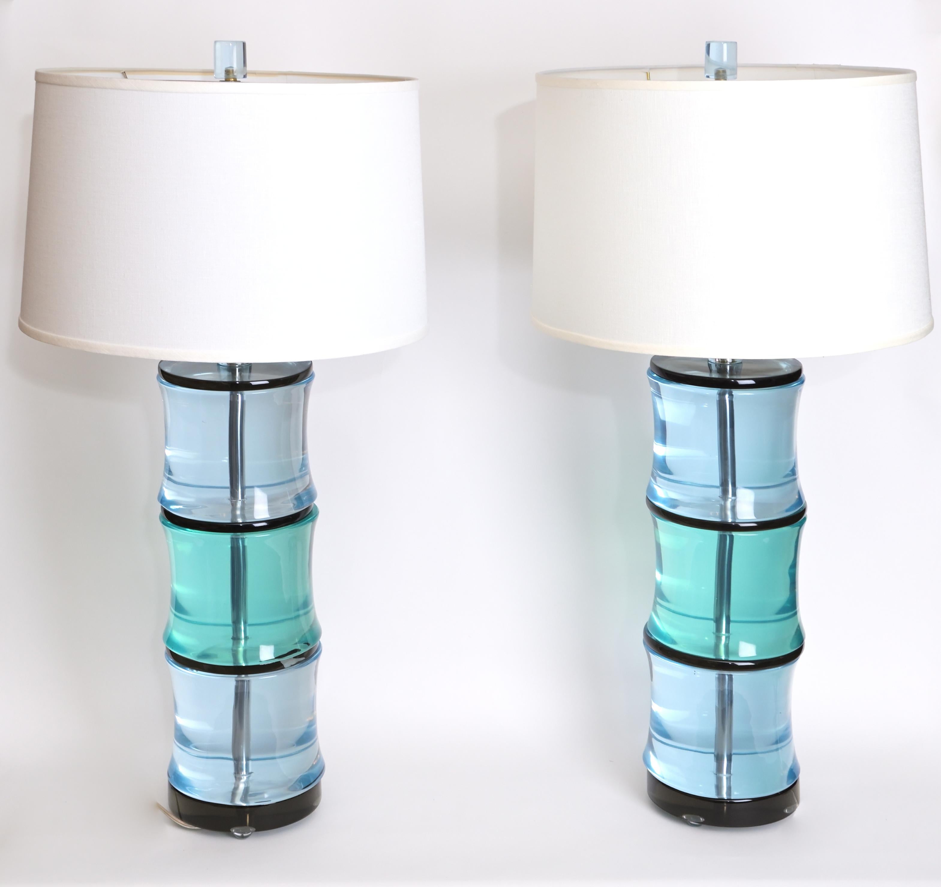 The Somerset Table lamps-- A pair of table lamps with peridot and aquamarine transparent cast resin sections with smokey topaz dividers forming bamboo-shaped lamp bases. Each lamp can accommodate two medium base light bulbs with 100 watts. Designed