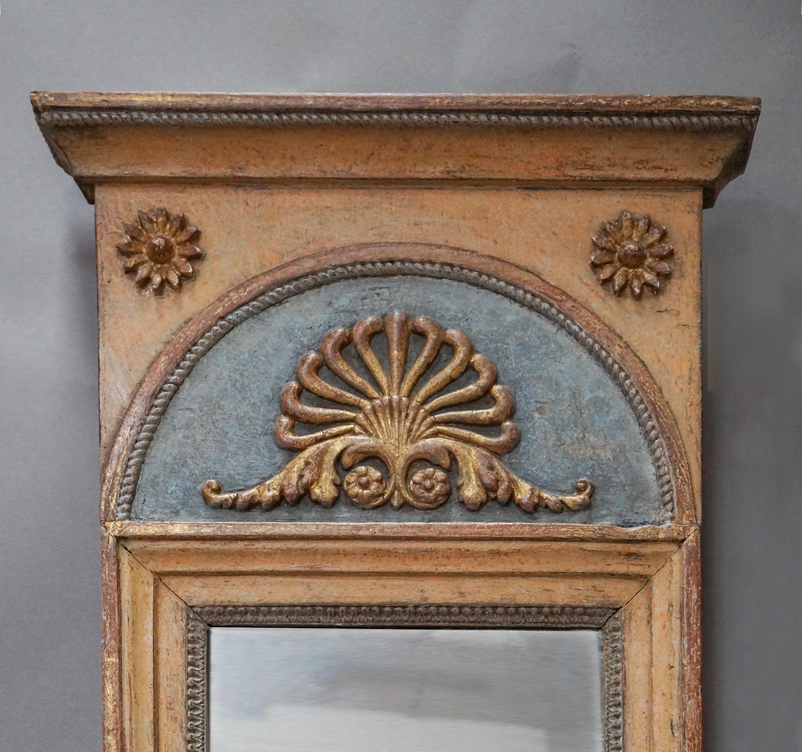 Pair of small Swedish mirrors from the Gustavian period, circa 1820. Original painted and gilded surface with a beautifully formed palmette above the mirror. Original mirror glass and back.
