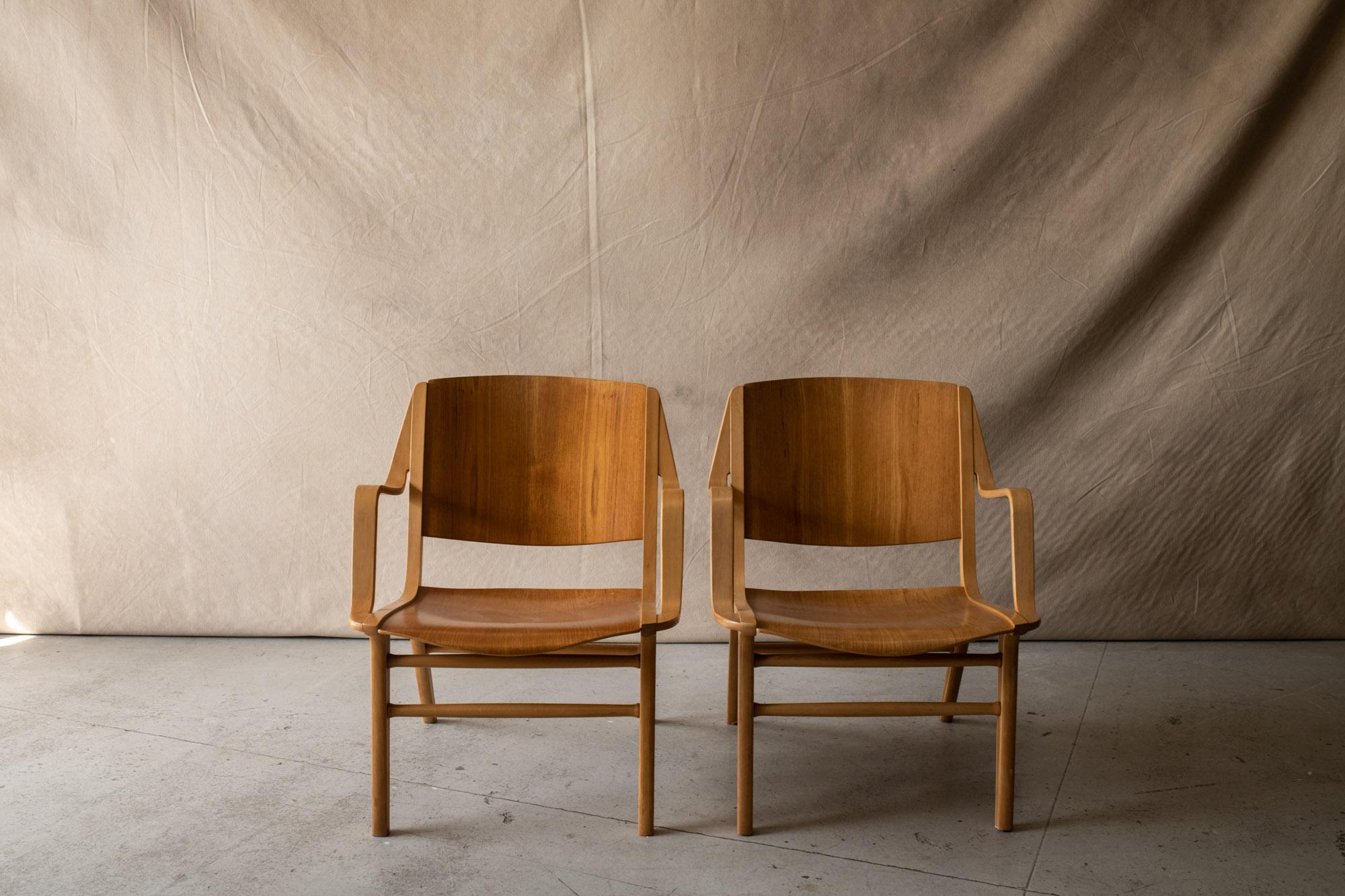 Pair of Peter Hvidt & Orla Mølgaard Nielsen Lounge Chairs, Model Ax, Circa 1960.  Molded Teak and beech wood construction with nice wear and patina.

We don't have the time to write an exhausting description on each of our pieces. We find it