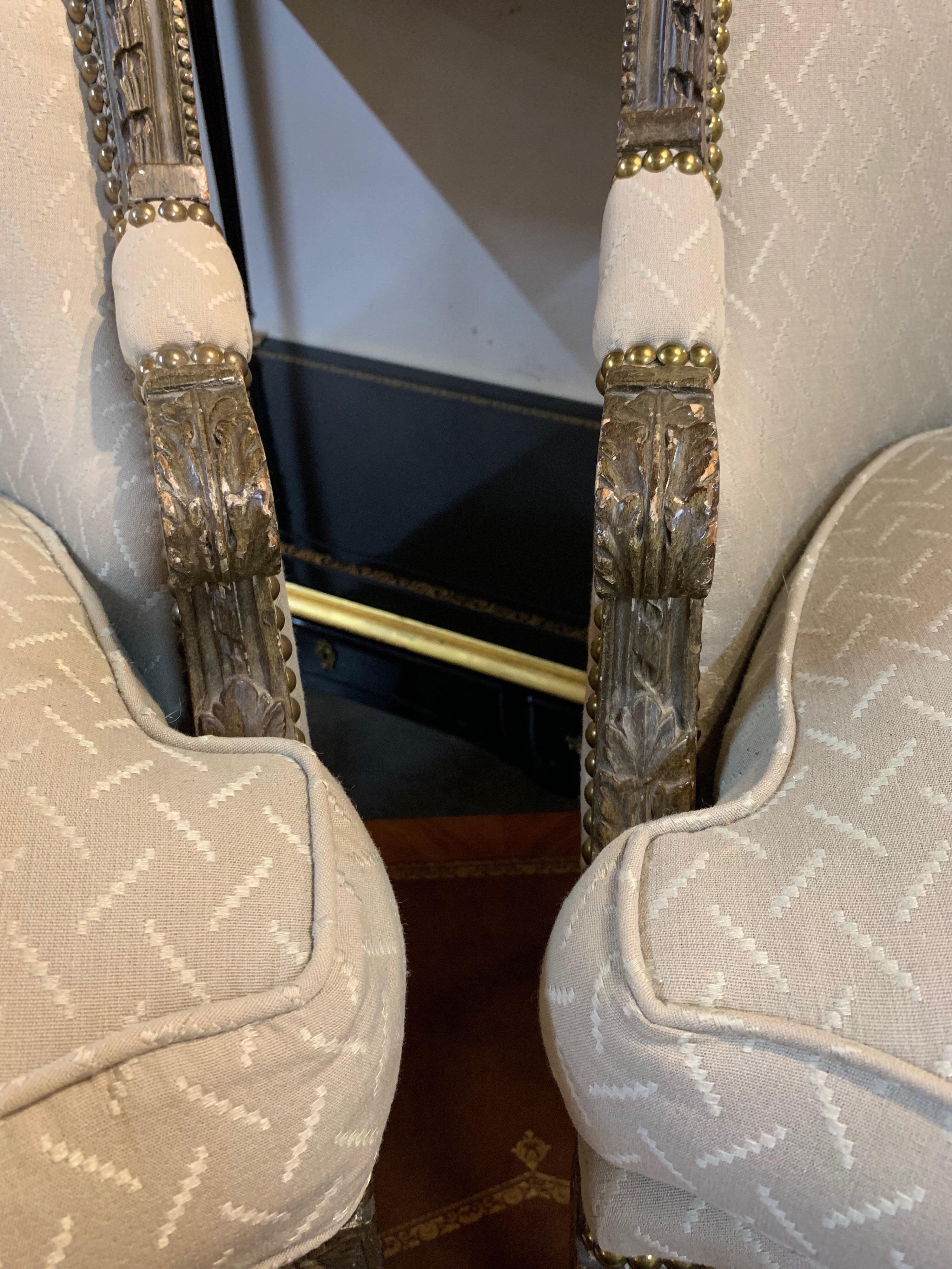 Lovely pair of petite 19th century French XVI carved and painted curved back chairs.
Very nice carving on the chairs and the upholstery is done in a beige and crème fabric. Please note: There is a small spot in the fabric on one of the chairs.